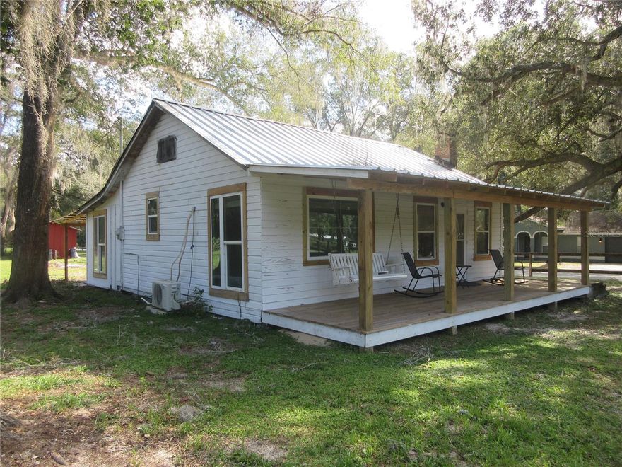 AUTHENTIC SELLER FINANCED LAKE ACCESS "FLORIDA CRACKER HOME" LOCATED IN THE FAMOUS OCALA NATIONAL FOREST! Do you want to live the way things used to be and buy a piece of history? Then come see this 1,020 sq ft cabin originally built in 1940 sitting on two gorgeous paved road corner lots totalling .65 of an acre. Sit on your breezy new 2025 8x33 open front porch shaded by a massive 21 foot in circumference Oak tree with it's huge arms reaching out towards the sunset. Or relax on the new 2025 10x33 open back porch overlooking your beautiful land. The entire home is covered by a new 2025 permitted metal roof. Outside also features permitted 2025 doublepane windows, twin 2025 mini split Heat & A/C units, 2024 well pump, 2024 electric to the well pump and some updated electric. Also Quantum Fiber Optics are now at the property. Inside features oak and pine hardwood floors with vinyl in one bedroom, bathroom barn door, tile kitchen counter with oak back splash, 2025 tankless water heater, 2025 washer & dryer, 2025 convection oven, three 2025 ceiling fans, 2025 4x6 picture windows in the bedroom, 2025 blinds, 2025 electric receptacles, 2025 double door refrigerator with ice maker, 2025 smart multi color lighting, 2025 glass top range and a 2024 attic fan. Most of the major items have been replaced. Some of the final finishing touches are left for the buyer to complete. NO HOA! You get a lot of country charm and character at a great price of just $149,000! OR YOU CAN BUY THE HOUSE AND JUST ONE LOT FOR $129,000 and the seller will install a new well prior to closing provided the buyer puts a $10,000 non-refundable deposit. The current well is located on the second lot. Either way the seller is willing to finance the property with $74,500 down and the seller will finance the balance at 8% interest at $711.94 per month for 15 years, or arrange your own financing. Home is located in the Ocala National Forest which affords you almost a ½ million acres of Forest to roam, 600 lakes, 2 rivers, Juniper Springs, Silver Glen Springs, Salt Springs, Swimming, Skiing, Big BASS Fishing, Boating, Camping, Hiking, Horse back riding and some of the best ATV riding anywhere. The Villages is only 26 minutes away! Daytona Beach is just 1 hour away. Let the fun begin! You need it!