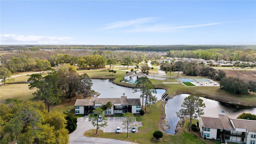 Set in a prime location within the Sandalwood condominium community, this condo features a bright, open layout anchored by a real wood-burning fireplace that adds warmth and character. The living and dining spaces connect easily, creating a comfortable flow for everyday living.

The kitchen features stainless steel appliances, generous cabinetry, and ample counter space. Two well-sized bedrooms offer flexibility for guests, a home office, or additional living space, along with a laundry area within the unit.

A unique feature of this unit is the two separate entrances, allowing the layout to be easily converted into two private living spaces, each with its own bedroom and bathroom—ideal for guests, extended family, or rental potential.

Residents enjoy access to community amenities including a pool, pickleball courts, and scenic lakefront surroundings. Sawgrass Grove in The Villages is approximately a five-minute drive, and Brownwood Paddock Square is about ten minutes away—both offering dining, shopping, and free nightly live music. Enjoy all the benefits of The Villages lifestyle while living just minutes away.