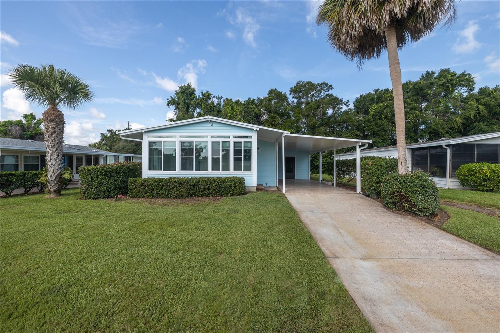 UPDATED THROUGHOUT LARGE BBEAUTIFUL (2084 sq. ft.) HOME IN INTRACOASTAL COMMUNITY in 55 or older community with LOADS OF ACVITIES INCLUDING RESIDENT BOAT RAMP. SUN ROOM on the front is insulated, split a/c/heat and blinds with two separate entrances. Drink your coffee in a beautiful setting with the sun coming up from the east. The updated kitchen is a chef's delight. All appliances purchased 2016/17. Metal roof, hurricane rated windows, termite bond. Porcelain Ceramic tile throughout except for woodshop floor. Hardy back is on whole house. The addition was added to the original home. Engineering drawings are available. Large room in the back was a craft room. There are a lot of uses it could be used for including an exercise room. Lots of lighting. Bathroom off the great room has a roll in shower and grab bars. This bathroom also has concrete walls and ceiling and is built on a solid concrete pillar. It has a steel door. It is sturdy and can be a storm room. Murphy bed and desk could be moved to any place in the home. Recommend Murphy installers.