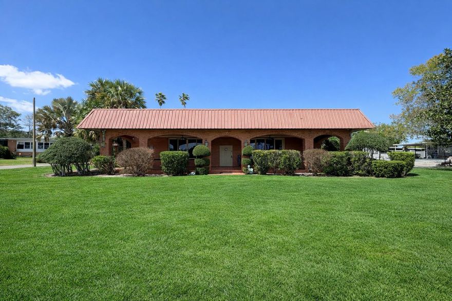 Stunning 4 bedroom, 4 bathroom pool home on over 1 acre with private pond views—offering space, privacy, and unique character you won’t find anywhere else. This beautifully maintained property combines solid construction, thoughtful updates, and versatile living spaces, making it ideal for both everyday living and entertaining.

The home features an expansive 43x23 great room with 10-foot ceilings, a cozy fireplace, built-in bar, and large windows showcasing serene water views. Originally built with commercial-grade standards and later used in part as a place of worship, the home includes distinctive architectural details and custom built-ins that add charm and functionality throughout.

The updated kitchen includes upgraded appliances, quality cabinetry, Corian countertops, and a stylish tiled backsplash. A split-bedroom layout provides privacy, including a bedroom with its own private entrance—perfect for an in-law suite, guest quarters, or home office.

Step outside to your private backyard oasis featuring a screened-in pool and spa, beautiful paver deck, outdoor shower, and fully fenced yard. The expansive covered patio and impressive 60+ foot front verandah with brick flooring and arched openings with multiple spaces to relax and enjoy peaceful pond and nature views.

Additional highlights include updated bathrooms, newer roof, dual-zone A/C systems, and updated windows for added comfort and efficiency.

Located on two adjoining parcels, this property offers over an acre of land with endless potential—perfect for those looking for a private retreat, multigenerational living, or a unique property with character.

Don’t miss this rare opportunity to own a pond-front pool home with acreage and unmatched charm.