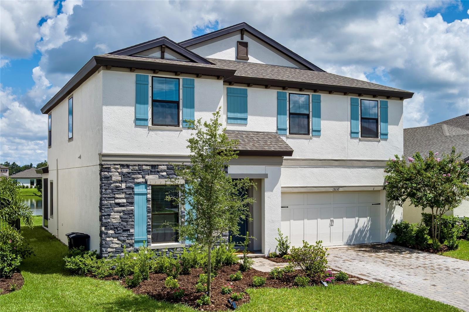 Enjoy pond views, luxurious upgrades, and a prime Crosswind Point location in this brand-new Homes by WestBay build. This 2024 residence in Crosswind Point blends luxury, comfort, and convenience in one remarkable package. With 4 bedrooms, 2.5 baths, and a 2-car garage, the home offers an ideal balance of space and thoughtful design—all enhanced by a peaceful pond view lot. From the moment you arrive, the European Country elevation with stone accents sets a tone of elegance. Inside, soaring 9.5’ ceilings and 8’ interior doors create a sense of openness, while expansive 8’ sliding glass doors connect indoor living to an extended lanai overlooking the water. The floor plan has been enhanced with exceptional upgrades: a versatile den conversion perfect for work or play, an alternate primary bath with both soaking tub and shower, and an additional sink in the secondary bath for everyday convenience. Brass floor outlets in the living room add function without sacrificing style, and the laundry is pre-plumbed for a future tub to simplify busy routines. The kitchen is a chef’s delight with gas appliances, modern finishes, and room to gather. A tankless gas water heater and pre-plumb for a water softener add efficiency and value to everyday living. Crosswind Point places you near future shopping, fine dining, and a brand-new HCA hospital. With easy access to I-75, commuting is simple—whether your destination is Tampa, St. Petersburg, Lakewood Ranch, Sarasota, or even Orlando. More than a house, this is a home designed to adapt, inspire, and provide the comfort you’ve been looking for.