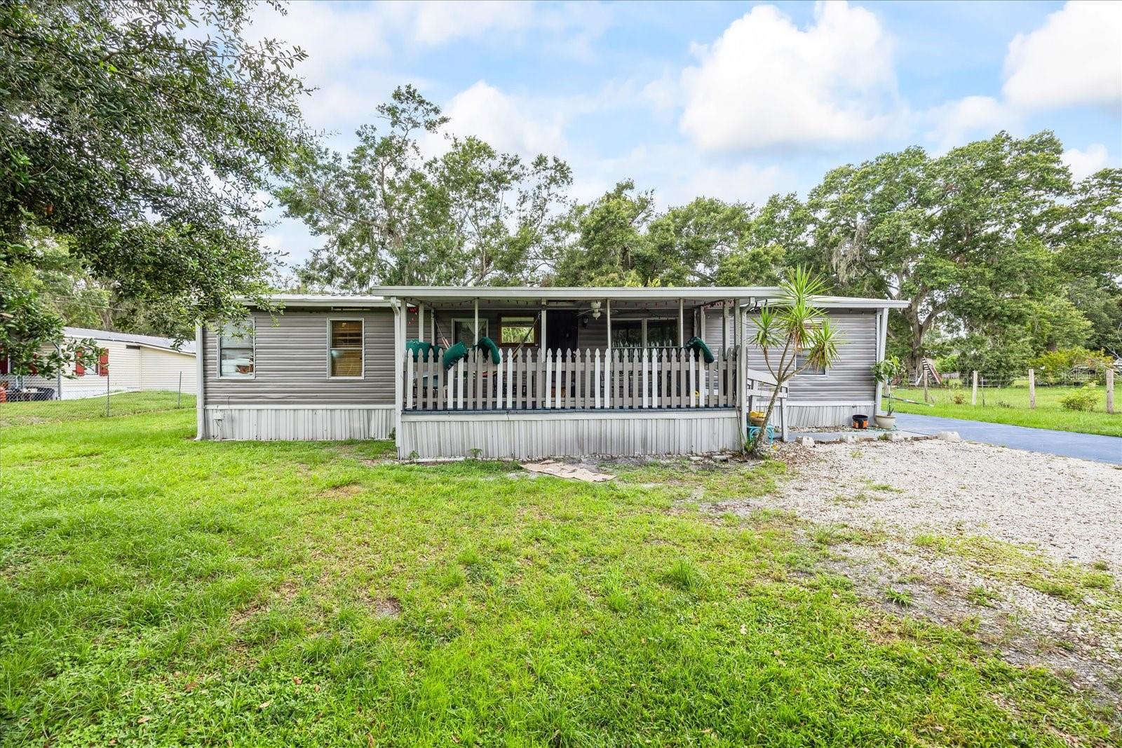Welcome to this spacious 3 bedroom, 2 bathroom double wide home nestled on just under an acre of serene Florida rural living. This property offers the perfect balance of privacy, comfort, and convenience with plenty of room to spread out and enjoy the outdoors.
Step inside to find a bright and open floor plan featuring a generous living area, well-appointed kitchen with ample cabinetry, and a dedicated dining space ideal for gatherings. The primary suite offers a private bath, while two additional bedrooms provide comfort and flexibility for family, guests, or a home office.
Outside, the expansive lot gives you endless possibilities — from creating a garden oasis to adding a workshop, pool, or play area. Mature trees provide natural shade, while the wide-open space allows you to truly make the property your own.
Located in the peaceful rural enclaves of Lakeland, this home delivers a quiet, country feel while keeping you close to shopping, dining, schools, and major highways for an easy commute, including easy access to I-4 for a smooth commute to Tampa or Orlando. Schedule a showing today! Don't miss this opportunity to own a lovely home on a large lot in one of Central Florida’s most desirable areas.