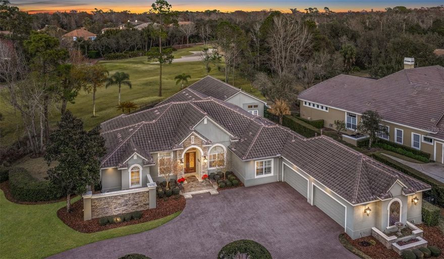 You truly can have it all in this exceptionally private golf-front estate in Alaqua Lakes—featuring no neighbors on the left, none in front, and breathtaking panoramic golf views from the rear; complete with a GUEST HOUSE!! Perfectly positioned on over six-tenths of an acre in one of Seminole County’s most sought-after 24-hour guard-gated communities, this residence offers both luxury and privacy at every turn.  A replaced tile roof(2020) with radiant barrier and natural gas backup generator(2020) bookend a myriad of upgrades and enhancements at this highly modified Taylor Woodrow flagship "Prestancia" floorplan. Designed for grand living, this ONE LEVEL, 5 BED 5.5 BATH home boasts a massive 4-car garage and a separate guest retreat complete with its own wet bar, bonus room, full bath, and private bedroom/workout room—ideal for leisure time, entertaining, or multigenerational living. Every bedroom is generously sized and appointed with expansive walk-in closets, custom closet systems; 3 of which have their very own ensuite bathroom. Pocketing sliding glass doors seamlessly blend indoor and outdoor living, opening to a sparkling pool and expansive outdoor entertaining area overlooking Alaqua Lakes’ renowned golf course. Embrace the Florida lifestyle on the oversized covered patio and summer kitchen, all while enjoying exceptional privacy with no neighbors on three sides and a tall hedge buffering the fourth. Architectural details abound, including custom tray ceilings in the dining room, rich solid wood beams in the family room, extensive crown molding, and designer finishes throughout—no detail overlooked. The chef’s kitchen is a showpiece, featuring a Wolf gas range, Sub-Zero refrigerator, extra-tall custom cabinetry, and a dramatic dual-sided fireplace shared between the living room and eat-in kitchen. A circular brick paver driveway welcomes you home and leads to the oversized 4-car garage, offering abundant space for vehicles, storage, and more. This is luxury golf-front living at its finest. As a resident of Alaqua Lakes, you'll have access to a unique 7-acre community park with an open-air pavilion, multipurpose field, tennis courts, and more—all just minutes from top-rated schools, upscale shopping, dining, business centers, and major highways. This property may be under audio/visual surveillance.