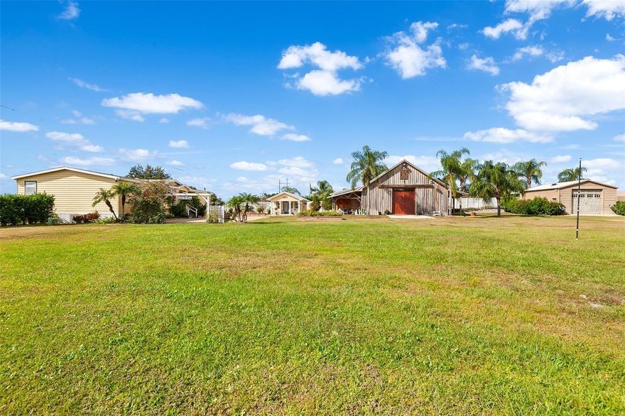 Discover endless possibilities with this remarkable 3 bedroom, 2 bath home set on over 3 acres with lake views and private lake access! Whether you’re envisioning an event venue, nursery, or home-based business, this property is ready to bring your dreams to life. The main home has been completely remodeled with gorgeous finishes and thoughtful details throughout. An abundance of windows fills every room with natural light, highlighting the trey ceilings, crown molding, and luxury vinyl plank flooring that add warmth and elegance. Stained glass windows adding a touch of character! The huge kitchen features Corian countertops, stainless steel appliances, and tons of cabinet space- perfect for entertaining or everyday living. Both bathrooms shine with quartz countertops and stylish fixtures. The barn expands the possibilities with two additional bedrooms, an office, storage space, a living area, full bath, and kitchen. It’s equipped with 200-amp service and a 12-foot door, ideal for an event venue, a workshop, studio, or guest accommodations. The charming “she shed” is cute as a button, complete with a half bath and outdoor shower—a perfect retreat for guests or creative projects. Outdoor living is equally impressive with huge patios and a whole-house generator. The entire property is fenced and gated, dotted with fruit trees, and offers ample space to relax or expand. With a roof (approx. 3 years old) and AC (approx. 5 years old), the big-ticket items are already taken care of. A rare combination of beauty, flexibility, opportunity and privacy, this property is ready to make your next chapter unforgettable.