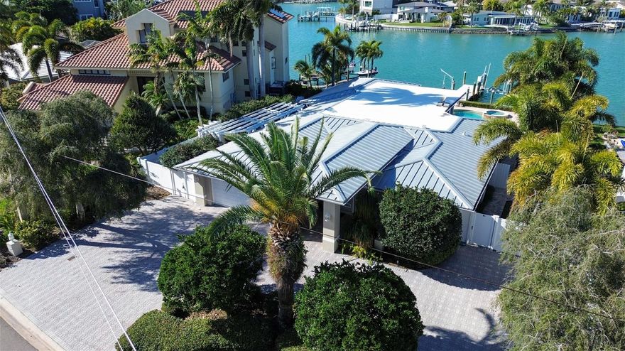 Welcome to 10074 Yacht Club Drive, a captivating haven for those who crave the perfect blend of boating and coastal lifestyle in Treasure Island. Easy one level living perfect for everyone. This meticulously remodeled residence boasts 4 bedrooms and 3 baths, mixing modern elegance and coastal charm.
 The expansive great room is flooded with natural light, offering pool and Inter Coastal water views and includes an enviable library.
Indulge your inner chef in the dream kitchen equipped with top-of-the-line appliances including an AGA dual fuel range. The custom pecky cypress cabinetry complements the sleek design and functional layout.
The salt water pool & spa  were designed with a modern concept, an ideal setting for peaceful retreats. The landscaping involves xeriscaping making it exceptionally easy to maintain.
The property features a boat dock and lift capable of accommodating a 15,000 lb. boat, along with a small craft davit. Whether you're an avid boater or simply love waterfront living, this home caters to your every desire.

Situated in the sought-after neighborhood of Paradise Island in  Treasure Island.  This residence provides a prime location with nearby access to beaches, dining, shopping, and entertainment—ensuring the coveted Florida lifestyle is at your fingertips. Don't miss the chance to own this exquisite home, where luxury, style, and innovation converge seamlessly. Schedule your private showing today 

One story waterfront price just refreshed to BELOW  recent APPRAISAL price of $2.45