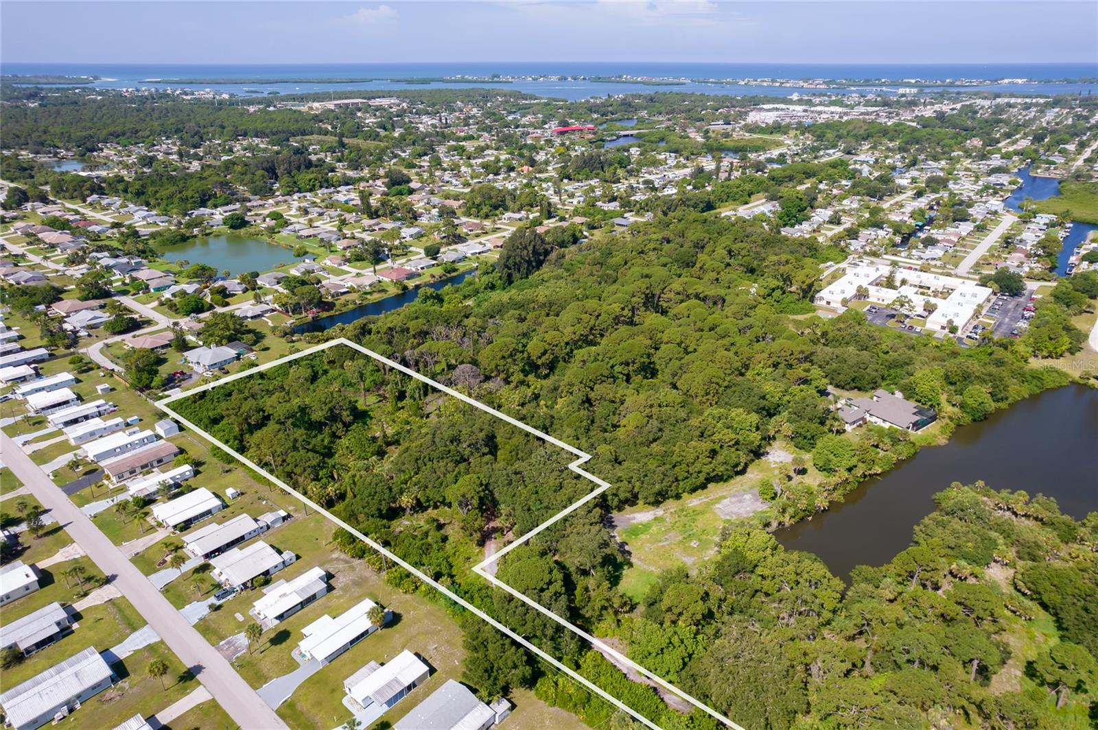 5 acres, Rare find in town within 3 miles of Englewood Beach yet extremely private. City water. Can be platted fit up to 5 lots. Gorgeous private driveway with sprawling Oaks