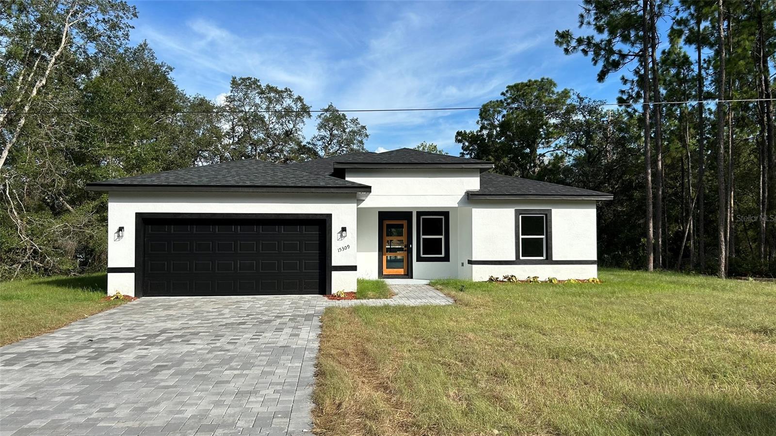 Welcome to this stunning 4-bedroom, 3-bath contemporary home offering 1,865 sq ft of heated space and 2,392 total sq ft. Situated on a 0.23-acre lot in Ocala, this brand-new construction home is move-in ready with sleek vinyl flooring, Samsung stainless steel appliances, quartz countertops, and a striking kitchen island with pendant lighting. A major standout is the expansive custom closet system in the owner’s suite — thoughtfully designed for organization and style. The spa-inspired primary bathroom features a freestanding tub and dual vanities, while the open floor plan flows effortlessly to a private backyard retreat. Seller offering concessions for closing costs. A rare blend of elegance, comfort, and functionality.