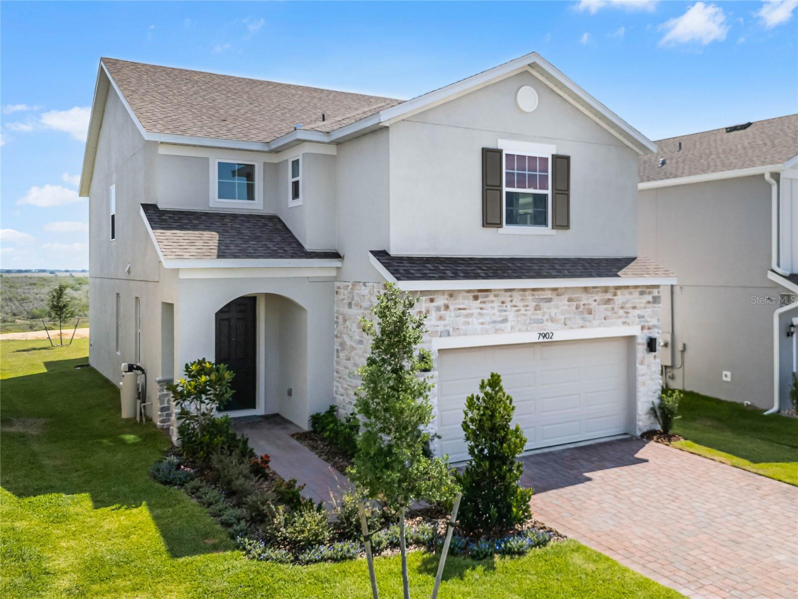 Experience the best of Florida living in this exquisite Landsea Sebastian home, now available for rent beginning October 1st in the gentle rolling hills of Clermont. This bright and open residence seamlessly blends modern touches with comfortable living, offering the perfect rental opportunity in a prime location. Situated just 25 minutes from Orlando, 20 minutes from Disney World, and minutes from Publix and downtown Clermont. This home is in the coveted Ridgeview neighborhood, next to the beautiful Lake Louisa State Park. As you approach the property, you’ll be greeted by a landscaped pathway leading to a two-car garage. Step inside to discover a stunning two-story foyer full of natural light, setting the tone for the spacious 9’4” ceilings throughout the main living area. The heart of the home is a chef’s dream. An oversized kitchen with a massive island perfect for entertaining, quartz countertops, white shaker-style cabinets, modern tile backsplash, and stainless steel appliances. For added versatility, a flexible downstairs room with beautiful French doors offers endless possibilities. Enjoy outdoor living on the screened covered lanai where you can even catch glimpses of Cape Canaveral space launches. The yard is fully fenced, providing a secure space for pets or outdoor activities. Upstairs, you’ll find a spacious layout including a large loft area and a primary suite that is a true retreat, complete with a walk-in closet and a luxurious subway-tiled shower featuring a modern shower system with a rainfall showerhead. Both full bathrooms include double vanities and private water closets for added convenience. This modern home is equipped with excellent amenities, including a whole-house water purification and softening system and roller shades. This rental property offers the perfect blend of comfort and luxury. Don’t miss the opportunity to make this stunning Clermont gem your home—schedule a tour today and experience Florida living at its finest.