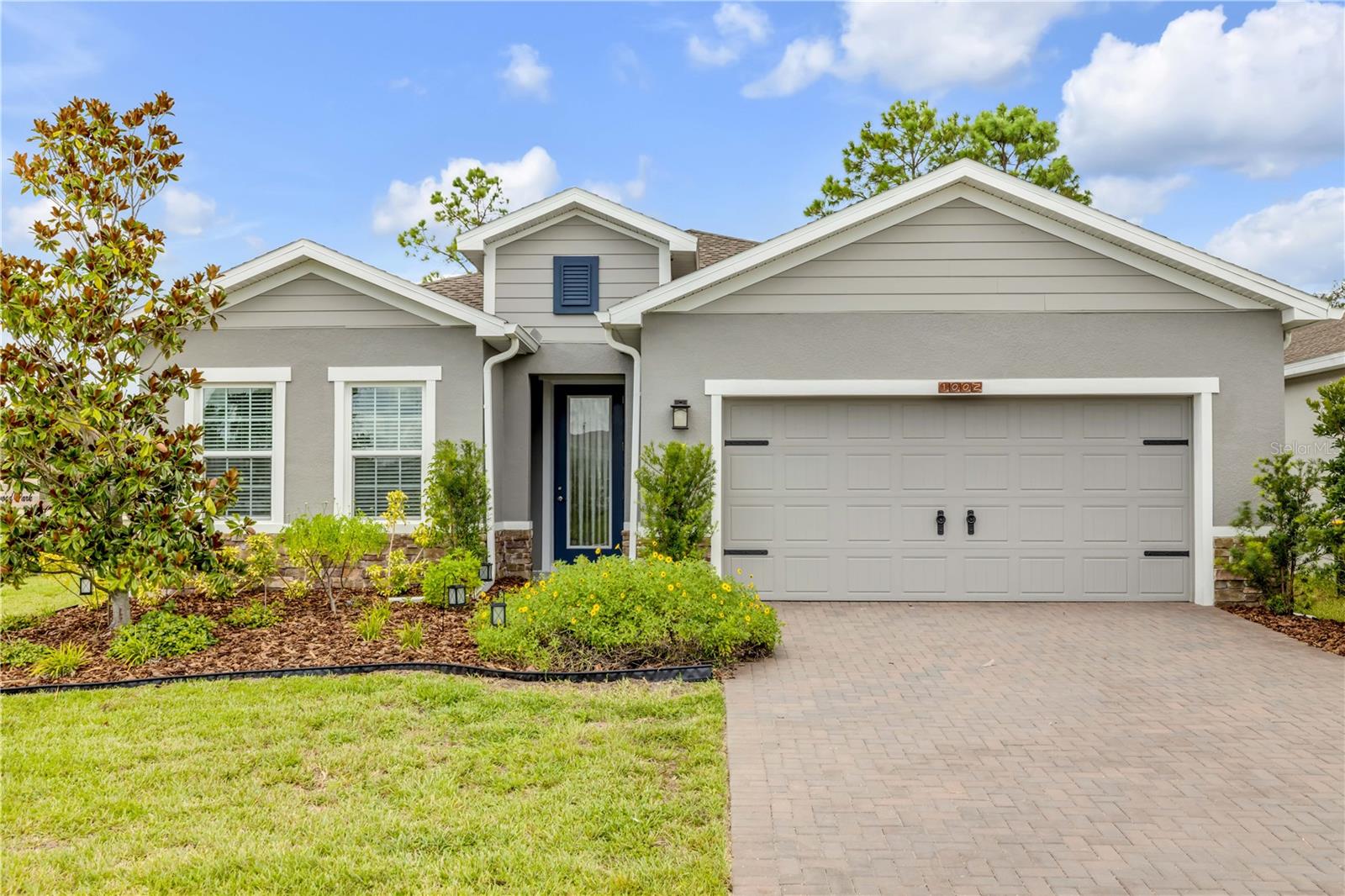 Welcome to this beautifully designed 3-bedroom, 2-bath home with a versatile office/den, built in 2023 and located on a desirable corner lot in Lakewood Park. This residence combines modern architecture with thoughtful upgrades, featuring an elegant stone-accented exterior, paver driveway, and a spacious 2-car garage.
Inside, the open floor plan is filled with natural light and flows seamlessly from the living area to the gourmet kitchen, complete with quartz countertops, premium appliances, and custom cabinetry. The primary suite is a true retreat with a spa-inspired ensuite bath, including an upgraded shower with a built-in seat, floor to ceiling tile and an expansive walk-in closet. Luxury vinyl plank flooring enhances the main living spaces, while plush carpeting adds comfort to each bedroom.
Professionally installed rain gutters, a reclaimed-water sprinkler system, and meticulous landscaping create exceptional curb appeal. Outdoors, enjoy a private patio perfect for relaxing or entertaining, as well as access to the community pool and playground for added lifestyle amenities.
This home offers a rare combination of modern elegance, functional design, and an ideal location—perfect for buyers seeking quality, comfort, and convenience.