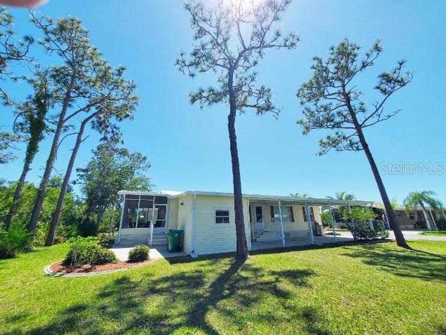 Become an Active Resident at Sunny Florida's 55+ Community Blue Heron Pines: 29200 Jones Loop Rd., Lot #125, Punta Gorda, Fl. 33950. Centrally Located to Airport's/Golf/Disney/Beaches & Braves or Ray's Sport's & More!  Partially Furnished. Approx. 1152 sq. ft. 2003 Home of Merit manufactured Home. Three BedRoom Two Bath 4 Car Carport with Golf Cart Garage on an OverSized Lot with a BackYard Oasis! Golf Cart Negotiable. UpDates: Entire Home Water Softner by Rain Soft. Roof-Membrane. A/C maintained by Four Season's. 2024: Home Pressure washed. 2023: Washer & Dryer & Stainless French Door Refrigerator. 2020: Hot Water Heater. No Microwave. Enter into Vaulted Ceilings OPEN CONCEPT New Age Decor. Honey Oak Flooring. First Guest BedRoom will accommodate a Queen Size Grouping. Has a Full size currently. Guest Bath Tub/Shower Combo. Second Guest BedRoom currently an Office with French Door's & a Lockable Closet in case You would like to Rent out Seasonally. Master BedRoom has 12" Tile Flooring. Queen Size Grouping in place now with Walk-In Closet. Can fit a King Size Grouping if you prefer. Master Bath has an Additional Extra Large Linen Closet for Storage. Dual Vanities with storage cabinets below. Shower has Seating Too! Home has Neutral Painted Drywall thru the Home. Kitchen w/ 3 Seating Breakfast Bar. Wrap Around Bevelled Glass above Cabinets & Below Cabinets for More Storage. Stainless Dual Sink. No Disposal, But! wired for one. Dishwasher, Flat Range & French Door Bottom Freezer Refrigerator. Laundry Alcove with Washer & Dryer included in the Sale. Breakfast Nook for Coffee Time. Exit thru Slider's to Your Extra Large 10" Tiled & Screened Lanai with a Scenic View of Mature Landscaping & an Additional Patio for Your Back Yard Entertaining! Call Today! for Your Personal Tour!