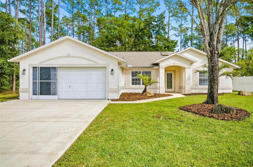 An Updated Florida Retreat with Style, Privacy & No HOA! Stop your search - you've found your new home in the heart of Palm Coast—where stylish design meets laid-back Florida living. This single-story, 3-bedroom, 2-bathroom home offers the perfect blend of comfort, function and style - all tucked away on a spacious lot with no HOA restrictions. Inside, you’ll find sleek ceramic tile flooring throughout, offering a seamless flow and effortless maintenance. The chef-inspired kitchen is a showstopper, featuring bold two-toned white and dark blue cabinetry, stainless steel appliances and striking finishes that make every meal feel special. A full laundry room adds everyday convenience, while the spacious primary suite delivers a true treat with tray ceilings, a walk-in closet, dual vanities and a stand alone shower. Step outside where you can unwind in your screened-in porch, overlooking a lush, landscaped backyard that backs to a serene canal and wooded areas—a private oasis for morning coffee or sunset gatherings safe from mosquitos. With plenty of room to grow, garden, or even add a pool, this property offers space and flexibility rarely found at this price point. Located in charming Palm Coast, you’ll enjoy easy access to award-winning golf courses, scenic parks, local shops, and coastal dining. Just minutes from Flagler Beach and the Atlantic shoreline, this home captures everything there is to love about the Florida lifestyle—sun, space, and serenity. Modern. Private. Perfectly located. This is Palm Coast living at its best—schedule your showing today before it’s gone!