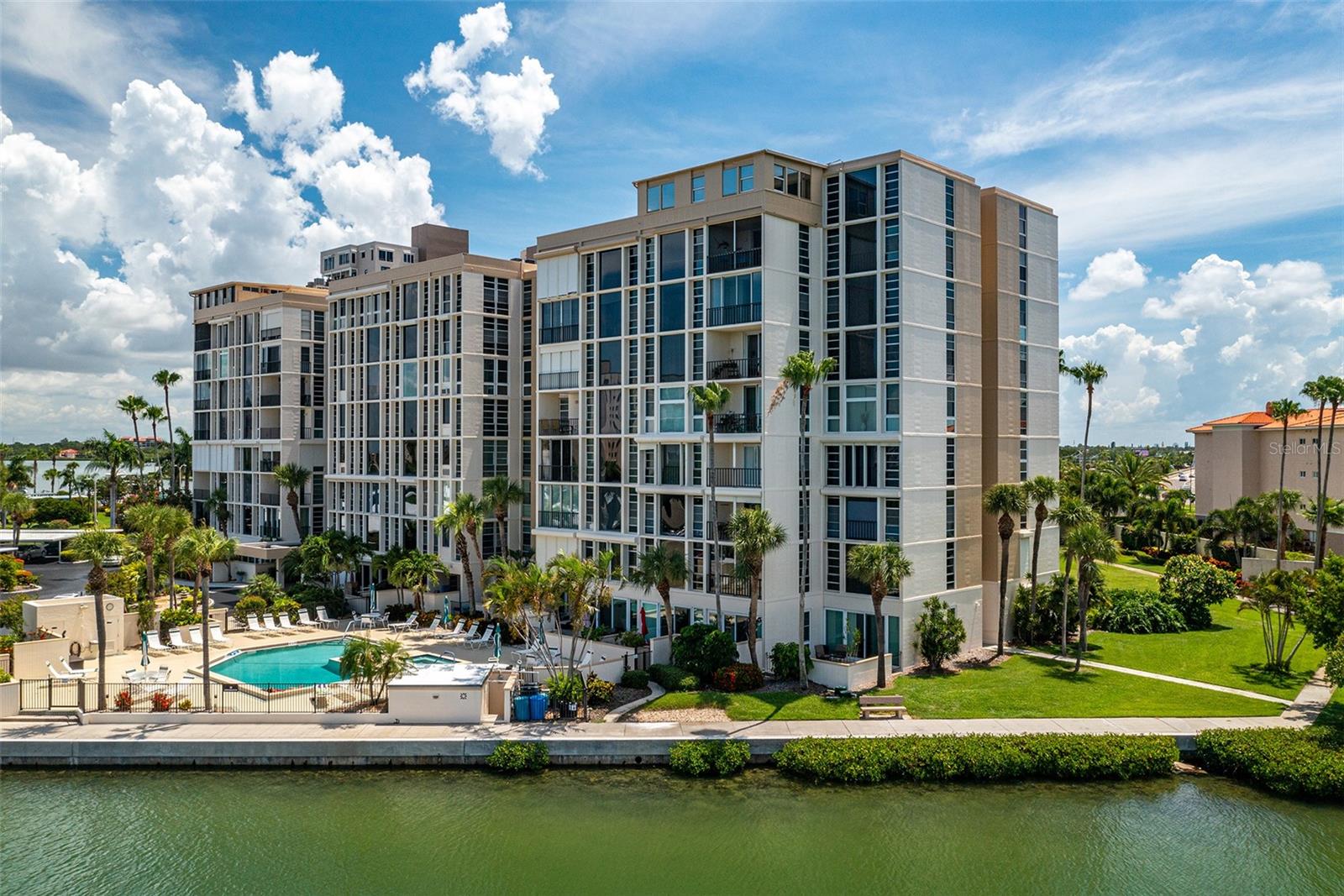 Welcome to Bay Island! Waterfront 55+ CommunityThis 4th floor end unit in the Ambassador building is bright and open with updated hurricane/impact windows, with relaxing views of downtown St Pete and Boca Ciega Bay. The air conditioning was replaced in 2019, and recent updates and upgrades include, stainless steel appliances, quartz countertops, new bathroom vanities and plumbing fixtures, new carpet in bedrooms, and new light fixtures throughout the home. Bay Island is a conveniently located 55+ community featuring 6 heated pools, 4 tennis courts, 4 shuffleboard courts, full fitness center, billiards room, library, oceanfront grilling areas, and a beachfront trail. 1.5 mile sea. It is an active 55+ paradise with many group activities within this well maintained gated community near St Pete Beach.