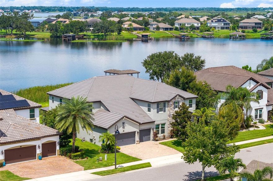 This amazing 7-bedroom, 6.5-bathroom home has been revamped to mix modern style with timeless elegance. Located in a prime spot with exclusive private access to the peaceful motorized Johns Lake, this place offers a rare blend of tranquility and privacy.

Step inside to find a perfect mix of style and comfort, with custom features built to suit any lifestyle. The main level features a spacious primary suite that feels like your own private retreat, and bathroom has been updated to bring you a spa-like vibe with classy finishes. The lower-level primary suite impresses with a huge walk-in closet, a comfy sitting area with French doors opening to the outdoors.

Practical touches include not one, but two laundry rooms, plus cozy built-in entertainment spaces with an electric fireplace to create a warm, inviting atmosphere. Upstairs, an awesome entertaining area awaits with a stylish built-in wet bar complete with granite countertops, a beverage fridge, and custom cabinetry. An impressive home theater with a top-of-the-line surround sound system, a projector, and a 120-inch screen is perfect for everything from lively parties to relaxed family movie nights.

This move-in-ready Winter Garden home is more than just a place to live—it’s a lifestyle. You’ll be just minutes away from world-class Orlando attractions like Walt Disney World, downtown Winter Garden, top-notch golf courses, and a variety of shops and restaurants. Plus, with easy access to the Florida Turnpike and I-4, you’ll enjoy breathtaking views and unbeatable convenience every day.
 
Home is zoned for the following public schools: Hamlin Elementary School, Hamlin Middle School, West Orange High School. There are a number of other schools in the area such as Windermere Preparatory and Montverde Academy.