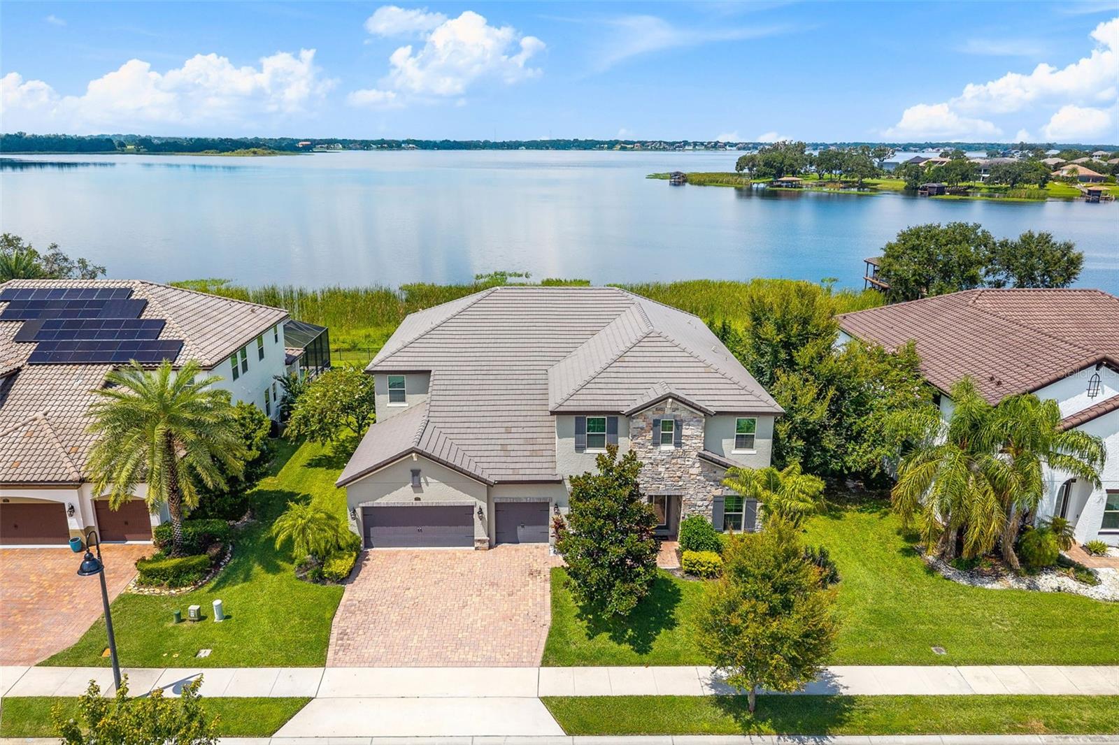 This amazing 7-bedroom, 6.5-bathroom home has been revamped to mix modern style with timeless elegance. Located in a prime spot with exclusive private access to the peaceful motorized Johns Lake, this place offers a rare blend of tranquility and privacy.
Step inside to find a perfect mix of style and comfort, with custom features built to suit any lifestyle. The main level features a spacious primary suite that feels like your own private retreat, and bathroom has been updated to bring you a spa-like vibe with classy finishes. The lower-level primary suite impresses with a huge walk-in closet, a comfy sitting area with French doors opening to the outdoors.
Practical touches include not one, but two laundry rooms, plus cozy built-in entertainment spaces with an electric fireplace to create a warm, inviting atmosphere. Upstairs, an awesome entertaining area awaits with a stylish built-in wet bar complete with granite countertops, a beverage fridge, and custom cabinetry. An impressive home theater with a top-of-the-line surround sound system, a projector, and a 120-inch screen is perfect for everything from lively parties to relaxed family movie nights.
This move-in-ready Winter Garden home is more than just a place to live—it’s a lifestyle. You’ll be just minutes away from world-class Orlando attractions like Walt Disney World, downtown Winter Garden, top-notch golf courses, and a variety of shops and restaurants. Plus, with easy access to the Florida Turnpike and I-4, you’ll enjoy breathtaking views and unbeatable convenience every day.
Home is zoned for the following public schools: Hamlin Elementary School, Hamlin Middle School, West Orange High School. There are a number of other schools in the area such as Windermere Preparatory and Montverde Academy.