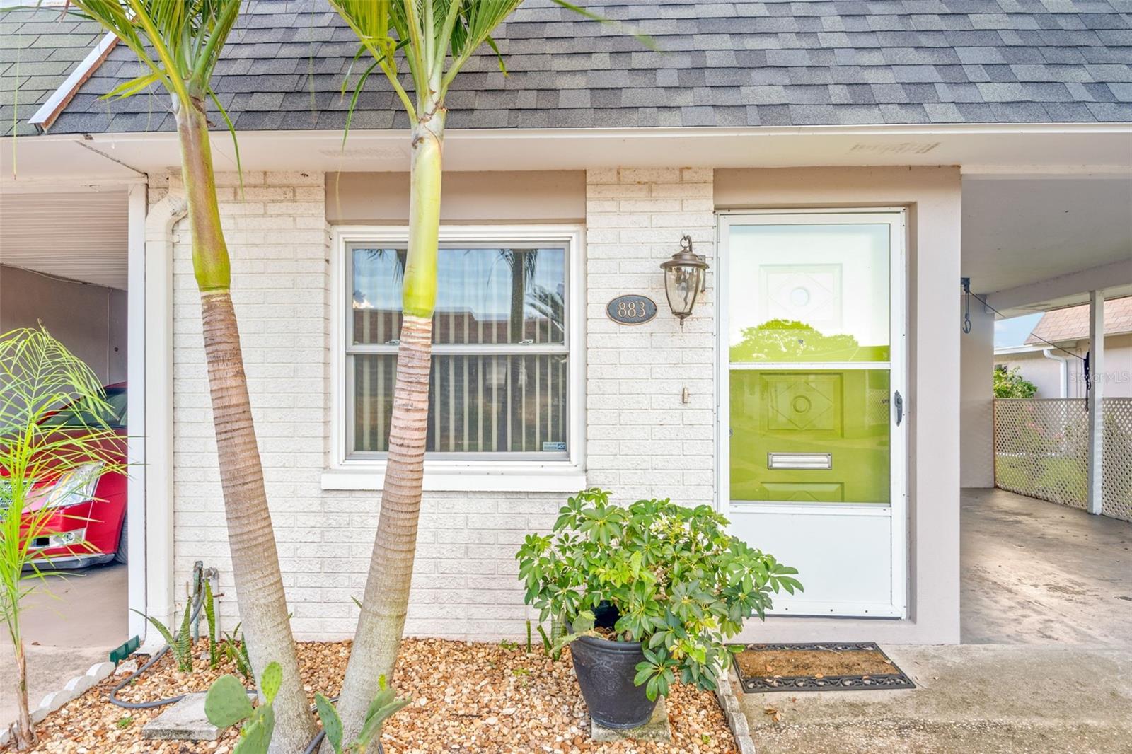 One or more photo(s) has been virtually staged. Discover this adorable 2-bedroom, 2-bath villa located in the highly sought-after and well-maintained 55+ community of Skye Loch Villas, just minutes from vibrant Downtown Dunedin! This move-in-ready home offers comfort, convenience, and charm—all in a peaceful neighborhood setting. As you step through the front entry, you're welcomed into a bright and spacious combined living and dining area featuring a ceiling fan with light over the dining space, additional overhead lighting for a well-lit, cozy atmosphere. There is new luxury vinyl flooring throughout the home as well as updated wide baseboards for a fresh, modern look. Continue down the hall to find a full guest bathroom with a tub/shower combo and updated vanity with extra drawer storage. Across the hall is a bright and updated eat-in kitchen featuring stainless steel appliances, a tile backsplash for a pop of color, and room for a bistro table or breakfast nook. Head toward the rear to your bedrooms. The first bedroom (guest room or flex space) offers direct exterior access to your own private patio, is light-filled with a ceiling fan/light combo and features a generous walk-in storage closet with ample built-in shelving. The primary bedroom is a spacious and peaceful retreat with a walk-in closet with plenty of storage, a sleek ceiling fan with light, and an en suite bath with step-in shower and modern vanity. There is a conveniently located hall linen closet with built-in shelving as well. Come and enjoy low-maintenance living in a well-kept community, complete with community pool and more! Only minutes to charming downtown Dunedin, shopping, dining, parks, trails, and Gulf Coast beaches, this villa offers a perfect blend of comfort and location for your next chapter. Whether you're downsizing or seeking a seasonal getaway, this is a rare opportunity to own a stylish and low-maintenance home in a prime 55+ community. Schedule your private tour today! Other features include newer windows, covered parking space and wonderful front storm door.