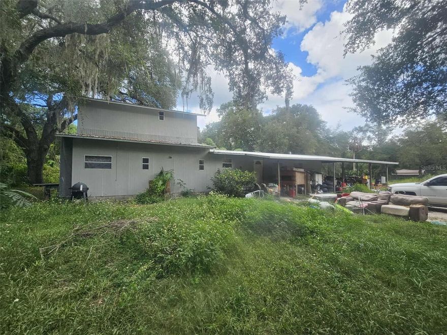 HANDYMAN SPECIAL!! Take a look at this manufactured home on a large lot in Ocklawaha, FL. The home has been expanded with a second floor to add more bedrooms. This home currently has 5 bedrooms and 2 bathrooms. There is a large carport and enclosed storage area. The dwelling needs repairs and updates, but there is a metal roof already in place (2016). Some of the subflooring on the first floor will need to be replaced. Unsure about the HVAC - window units are currently being used. This property is going through the probate process and does currently have squatters living in the home. CASH ONLY. Being sold AS-IS. Enjoy the Ocala National Forest with hunting, fishing, and other outdoor activities. The property is also close to many of Florida's most beautiful natural springs.
