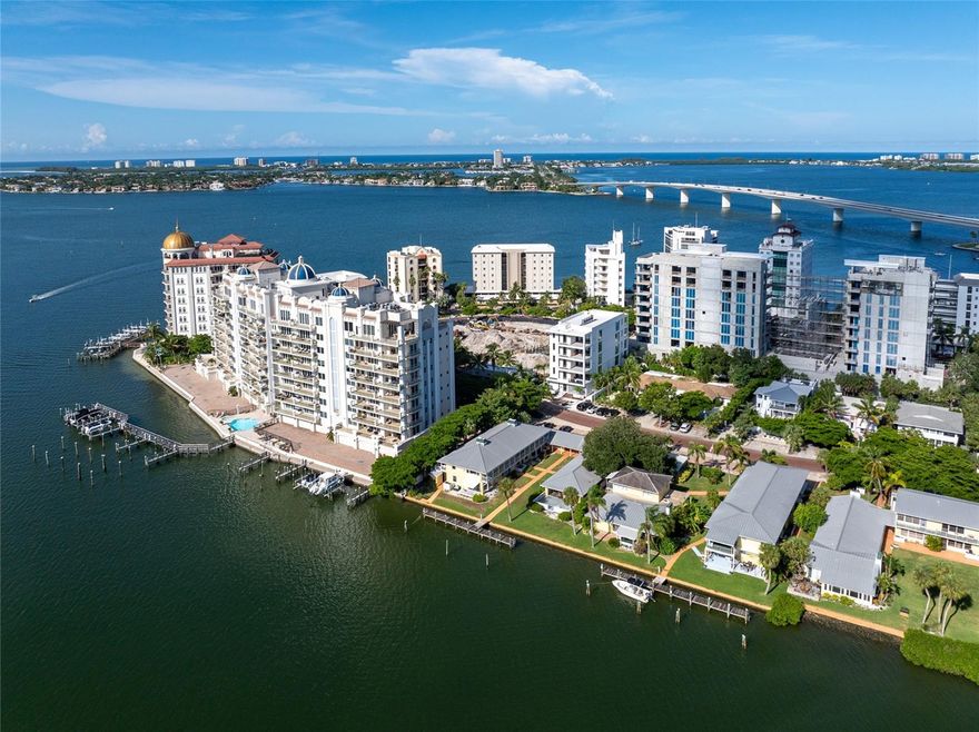 Brand-new, custom-built, and move-in ready, this full-floor condominium residence at En Pointe offers a rare blend of privacy, design, and elevated coastal living on Golden Gate Point. Set within a limited four-residence boutique condominium between the Ringling Bridge and downtown Sarasota, it delivers all the qualities of custom-home living with the ease and convenience of a lock-and-leave lifestyle. The residence captures views of Sarasota Bay, the marina, the downtown skyline, and the Ringling Bridge. Inside, the residence offers 2,439 square feet with 3 bedrooms and 3.5 bathrooms, plus two private covered terraces of approximately 350 square feet each—adding 700 square feet of exceptional outdoor living space. Designed as true extensions of the residence, the terraces easily accommodate open-air dining, a grill, and a generous lounge setting with TV hookup, creating an effortless indoor-outdoor lifestyle. Conceived in a neo-modern style by Echt Architects, the residence pairs refined craftsmanship with clean architectural lines and exceptional livability. A secured elevator opens directly into your private foyer, where walls of glass, expansive living spaces, and a chef-inspired kitchen create a residence that feels both sophisticated and welcoming. Spend evenings on the west terrace beneath the glow of the sunset, and begin the day on the east terrace with morning light over the marina—an elegant daily rhythm that feels distinctly Sarasota. The primary suite is spacious and serene, featuring a large walk-in closet, dual vanities, a soaking tub, an oversized shower, and direct access to the sunset terrace. Two additional en-suite bedrooms provide comfort and privacy for guests. Amenities at En Pointe include a heated saltwater pool, elevated decks for lounging and dining, two covered parking spaces, an EV charger, and ground-level bike storage. Just minutes to Main Street, St. Armands Circle, and Lido Beach, this is an exceptional opportunity to own a brand-new architectural condominium residence in one of downtown Sarasota’s most desirable settings.