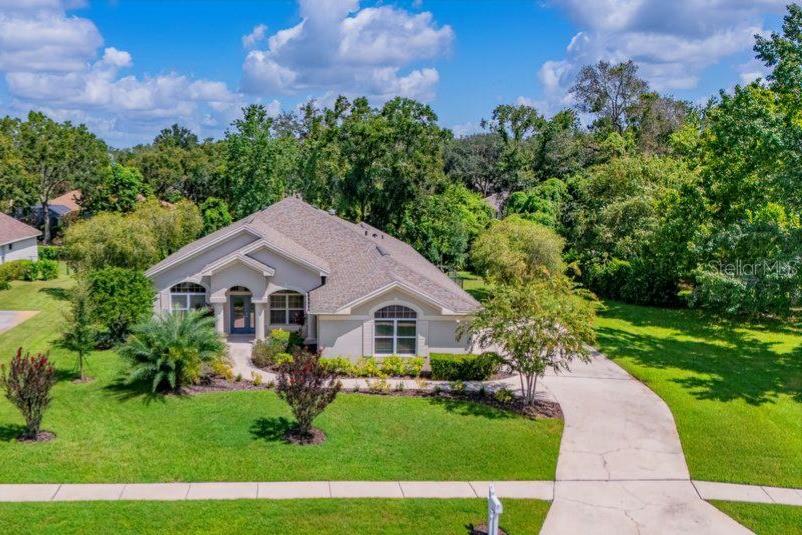 GATED FISH HAWK TRAILS! This Fabulous Arthur Rutenberg / One Story Home offers 3 beds / 2 baths / + BONUS ROOM (with lanai access – perfect for an office or guest suite!) / and a 3 CAR GARAGE on a TRUE CONSERVATION + CUL DE SAC LOT! Don't miss this incredible opportunity to own a home on a Phenomenal Homesite in the highly sought-after GATED community of Fish Hawk Trails! Nestled at the end of a quiet cul-de-sac on a wooded half-acre lot, this beautifully maintained residence offers privacy, space, and modern upgrades throughout. Step inside to discover an open floor plan with abundant natural light and a seamless flow between the formal living and dining rooms—accented by plantation shutters and a custom built-in island with storage and a new wine fridge. The updated kitchen is a chef’s dream, featuring off-white wood cabinetry, granite countertops, tile backsplash, stainless steel appliances, under-cabinet lighting, and a center island with seating. Adjacent is a cozy dining nook surrounded by windows, overlooking the lush outdoor space. The spacious family room opens to a large covered lanai and screened patio, perfect for relaxing or entertaining while enjoying views of the expansive, private backyard! The primary suite offers serene views and an upgraded En-Suite with dual vanities, a walk-in shower, and a large walk-in closet. Three additional bedrooms share an updated full bath, and a versatile bonus room with lanai access and a separate entrance is ideal for a home office or guest suite. Additional features include tile and LVP flooring throughout, a new roof (2017), new HVAC and water heater (2023), updated lighting and fans, and an oversized 3-car garage with cabinetry, counters, and a utility sink. Located in the prestigious Fish Hawk Trails, residents enjoy 24-hour guarded access, top-rated schools, serene nature trails, playgrounds, and sports facilities. Conveniently located to shopping, restaurants, Golf Courses, Gulf beaches and MORE! This home is a must-see—schedule your private showing today!