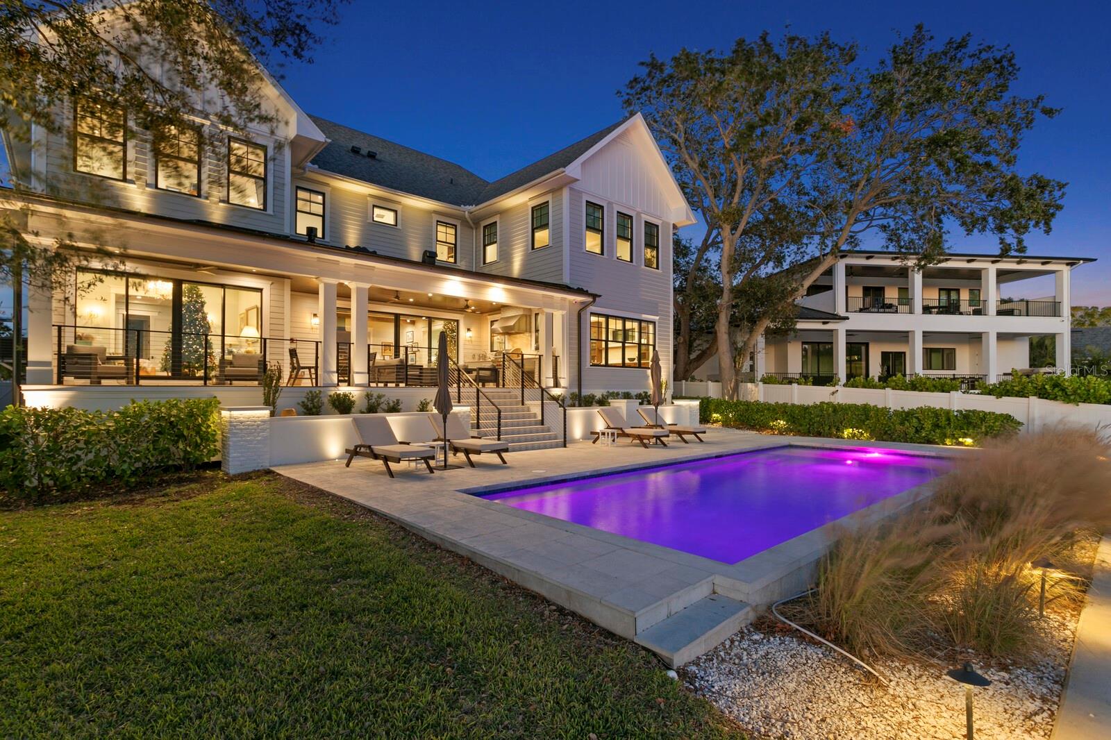 Located in the Poet’s Corner of South Tampa, this 6,479 square foot, 6-bedroom, 6.5-bathroom waterfront estate redefines modern luxury. Built in 2023 by local builder, Sunset Properties, the home is a perfect blend of cutting-edge technology and exquisite craftsmanship throughout. Features include a state-of-the-art Control4 system that seamlessly manages in-ceiling speakers, four climate zones, lighting, and a Protect security system with seven outdoor cameras. Hurricane-rated Marvin windows and sliders, remote-controlled blinds. The European oak flooring throughout the home adds both elegance and functionality. Custom Closets-by-Design storage solutions are found in every bedroom, as well as in the pantry, laundry, and hall closets, ensuring every space is as practical as it is beautiful. An open living concept captures views of the water from all main areas of the home. The chef’s kitchen is equipped with Subzero, Wolf, and Cove appliances, quartz countertops, 36” farm style sink, and a pot filler over the dual-fuel range with double ovens. Although new construction, a bit of Tampa's history resides in this home. The pantry door, from Schiller’s architectural salvage, was an original door from the Tampa Courthouse office of Judge Mark A. Pizzo. The family room is anchored by a natural stone gas fireplace, while the dining room features custom cabinetry, a bar sink, icemaker, and a wine refrigerator. The main level media room offers a true cinematic experience with remote blackout shades, an 83-inch Sony Bravia TV, and high-end surround sound. The thoughtfully designed layout includes a full in-law suite on the first level. The second level primary suite has an expansive walk-in closet with center island and windows for natural light. The spacious primary bath has a zero-entry shower, free standing bathtub, dual vanities and custom cabinetry. Additional bedrooms, all located on the second level, feature en-suite bathrooms and walk-in closets. To slow down at the end of the day, step outside to your private oasis. The covered lanai has an Espresso stained tongue in groove plank ceiling with remote control fans. The full outdoor kitchen with Wolf appliances will bring out your inner grill master. Ignite the fireplace, relax and enjoy. An 11’x 36’ saltwater pool, with a sun shelf, is perfectly placed overlooking open waters. The extended height seawall, built in 2022, private dock with Trex decking, and 10,000 lb capacity boat lift with new stainless steel motors make this property ideal for waterfront living. Additional amenities include laundry on both first and second levels, a whole-home water filtration system, two Rinnai tankless water heaters, a 24kw whole house Generac natural gas generator, and an attached three-car garage with epoxy flooring and 35-foot ceilings. Perfectly situated in a premier location within the Dale Mabry/Coleman/HB Plant school district, and minutes to both the Downtown Tampa and Westshore business districts, Channelside and Waterstreet. This home offers an unparalleled lifestyle of elegance, comfort, and sophistication. We look forward to seeing you.