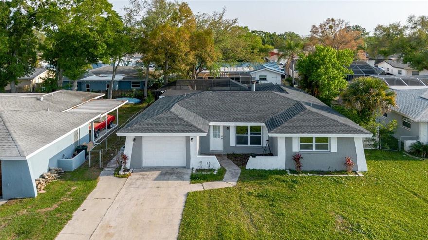 SELLERS ARE OFFERING $5000 CREDIT TOWARDS BUYER'S CLOSING COSTS AND ARE VERY MOTIVATED!!! Come enjoy your next recently updated pool home located in Oldsmar with an open living room and dining room that feature vinyl floors throughout the entire interior of the home! This home attributes natural light throughout the whole house and makes a perfect setup for a family and gatherings. Come see your stylish kitchen that has built-in stainless appliances, marble countertops, and a natural stone ledger backsplash that enjoys a bar setup to host company with the pool easily accessible just steps away through the glass doors to the outside.  The interior has been recently painted along with a new A/C Unit installed in 2025 so you have no problem getting a break from the heat. For your peace of mind, the roof along with the hot water heater were replaced in 2024. Delightfully, you are in close proximity to Sheffield Park and is a short drive to well known Philippe Park. If you don't want to go anywhere then there is a screened-in pool for your enjoyment without ever leaving the house. The seller has a recently passed 4 point inspection in July of 2025 and cuts down on uncertainty for the next owner of this home.