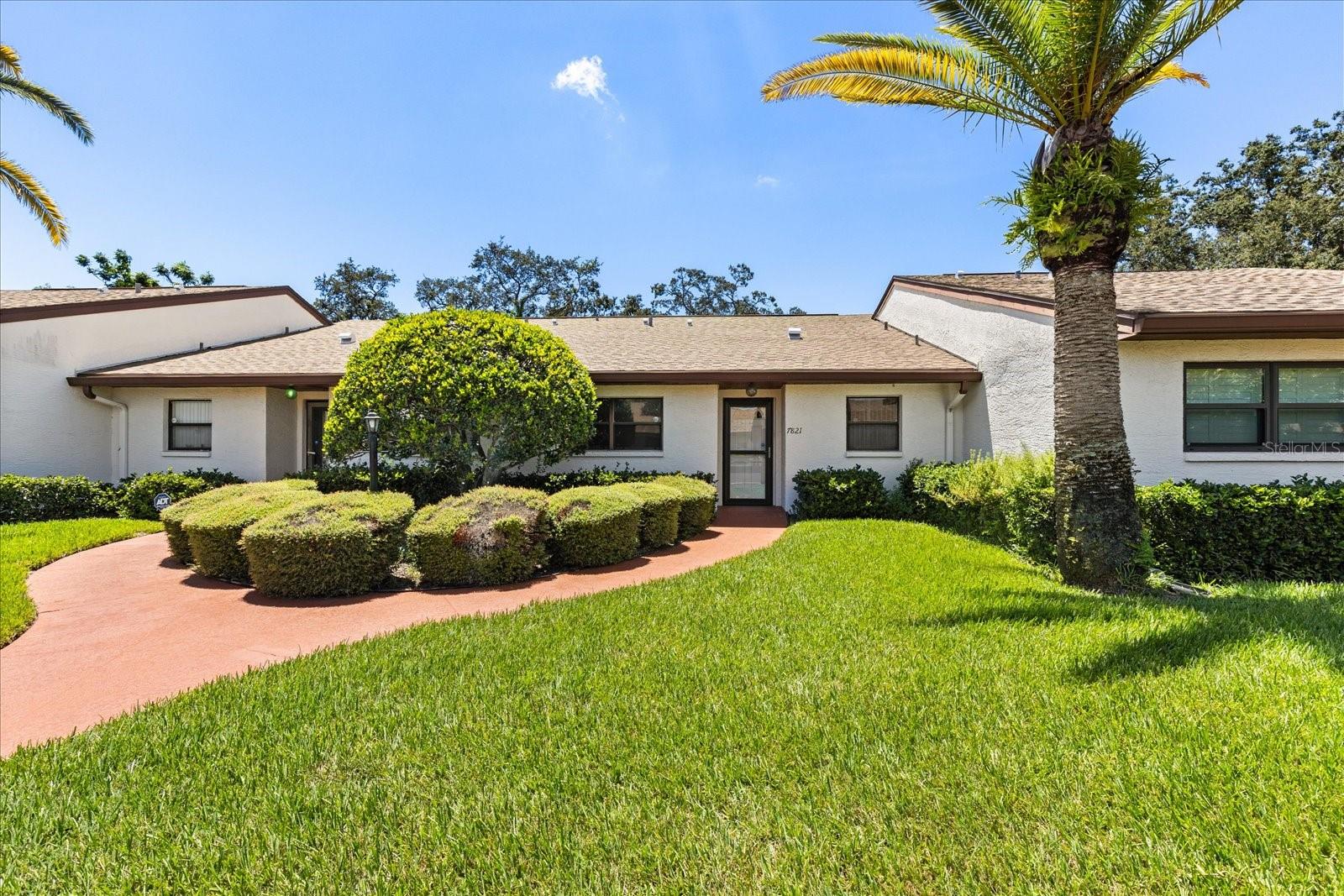Welcome to 7821 Radcliffe Circle, a beautifully maintained 2-bed, 2-bath, condo in the peaceful, gated 55+ community of Radcliffe. This spacious 1,248 sq ft home (plus a lovely enclosed and screened back porch) features an open floor plan, walk-in closets in both the guest and primary suites, and a convenient laundry area just off the kitchen. Enjoy easy access to the nearby clubhouse, community pool, and heated spa- all just around the corner from your front door! The home also includes one covered carport space, a private enclosed outdoor storage room, and even access to private attic storage space. Benefit from all kitchen appliances and washer and dryer that come along with this home. Located outside of a flood zone and just minutes from shopping, dining, and essentials like Walmart, Kohl's, and Hobby Lobby. You're only a 20 minute drive to the beach, and a 40 minute drive to Tampa International Airport. This is Florida living at its best- Simple, Comfortable, and Convenient, Call today to schedule a private tour!