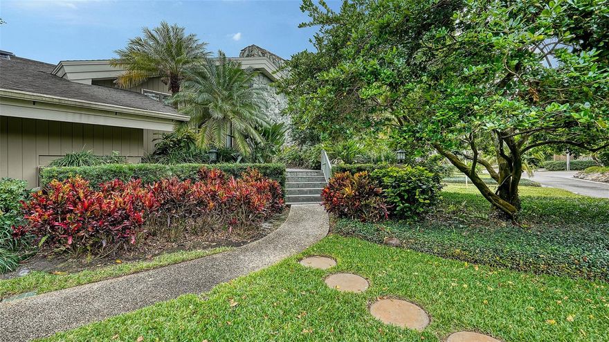 KIMLIRA… Welcome to this distinguished family estate, a true sanctuary nestled on over an acre of lush landscaping and majestic oaks, offering both privacy and tranquility. Designed by architect Arthur F. Mead and built by the respected contractor Thomas V. Hensey, this exceptional 4 or 5-bedroom home exemplifies the highest quality craftsmanship throughout and a sense of quiet luxury. 
The light-filled interior boasts soaring vaulted ceilings and an abundance of windows that bring the beauty of the outdoors in. 
The covered entry leads to an elegant foyer and spacious living room with a coral stone fireplace, built-in cabinetry, and extended hearth. The adjacent dining room is perfect for formal entertaining. The chef’s kitchen is complete with a large butler's pantry and a cozy breakfast nook that opens to one of two inviting family rooms. The primary suite is expansive, private and includes a beautifully appointed bathroom with custom cabinetry, two walk-in closets with built-ins, a marble shower and soaking tub. The other wing of the home starts with a large family room with built-in cabinetry (could be 5th BDR) and the additional three spacious bedrooms, each with ensuite bathrooms.
Step outside to a serene, zen-inspired private yard, perfect for peaceful moments. The screened porch is ideal for outdoor dining, while the 56-foot lap pool provides an invigorating escape. Both ends of the house have garages, one a two-car garage with a walk-through storage area that spans the entire length of the house offers incredible storage space. The other two-car garage has an elevator lift that ensures easy accessibility. Hurricane protection on all windows. The base floor is 12+ (according to previous elevation certification), with concrete walls, floors and stem wall (addition is wood). Located near the Landings and Field Club, this home offers a quiet setting, while remaining just minutes from shopping, dining, hospital, and the cultural attractions of downtown Sarasota, as well as the pristine white sands of Siesta Key. More than a home, it’s a serene retreat.