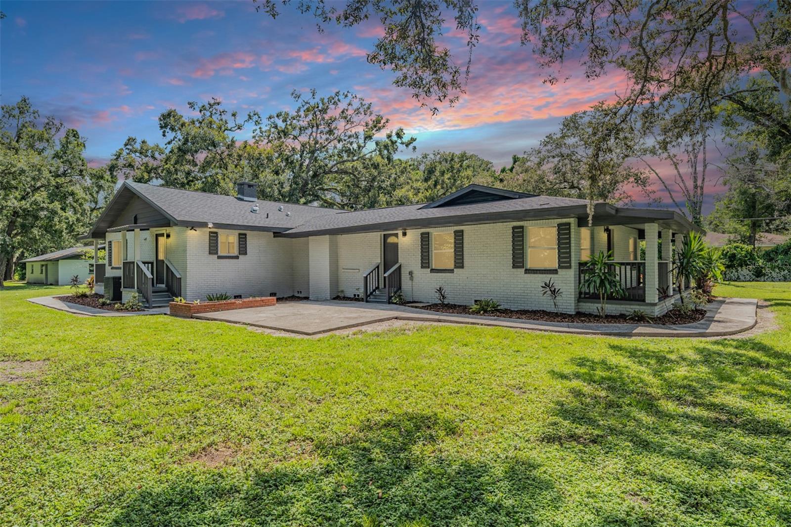 One or more photo(s) has been virtually staged. Welcome to 16415 Hanna Road – a beautifully renovated lakefront estate surrounded by million-dollar homes in the heart of Lutz. This rare find features a 3-bedrooms, 2-bath main home plus a duplex-style in-law quarters with its own private entrance, 2-bedrooms, 1-bathroom, kitchen, and den—perfect for multigenerational living, guest accommodations, or rental income. Inside, you’ll discover two cozy fireplaces, a fully renovated interior (2023), and all the major updates already completed: new roof, A/C, water heater, fresh paint, luxury flooring, and a chef’s kitchen with brand-new stainless steel appliances and shaker cabinetry. The main home includes all appliances plus a washer & dryer, while the in-law suite offers a full-size fridge & mini fridge , oven, dishwasher, microwave, and washer/dryer connection. Set on nearly 2 acres (pigs are the only restricted animals), this property is ideal for pets, small farm animals, or simply enjoying the open space. The chicken coop stays with the property, adding to its country charm. Relax and take in the serene lake views from the expansive yard, designed for both tranquility and entertaining. The exterior has been freshly painted and professionally landscaped, giving this home outstanding curb appeal. A massive detached 4-car garage with additional storage rooms provides plenty of space for vehicles, tools, and a workshop. For peace of mind and modern convenience, the home is equipped with smart locks, a Eufy security camera system (no subscription required), and a smart thermostat. Enjoy the best of both worlds—country serenity with city convenience. Located just minutes from Tampa’s shopping, dining, and top-rated schools, yet nestled in the privacy of your own slice of paradise.
