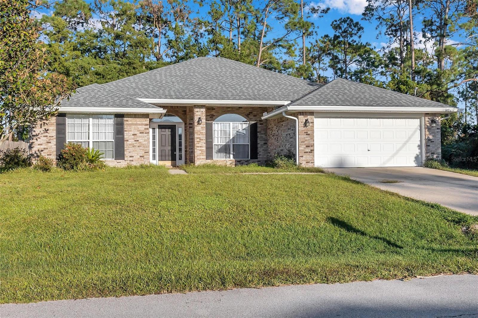 This beautifully maintained home offers one of the best price-per-square-foot values on the market! Featuring custom tile throughout and laminate flooring in the bedrooms, it boasts a dramatic floor-to-ceiling brick fireplace, spacious bedrooms, and ample closet space. The bright ensuite bathroom with a block window over the garden tub is a true retreat. Step through French doors to a private back patio overlooking a freshwater canal. Enjoy peace of mind with a new AC, fresh paint, and a new roof installed in 2021. This home is an absolute must-see!