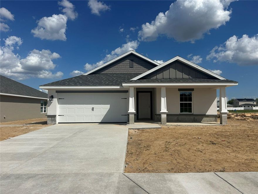 Under Construction. PROMOTIONAL TEMP PRICE REDUCTION ON CONTRACT SIGNED NLT 4-11-26. CONCRETE BLOCK CONSTRUCTION. Newly revised floor plan! Come see the enhanced version of the original popular 3/2 Split plan. Plenty of upgrades in this home. Begin with the Craftsman exterior showcasing stone accents, tapered columns and shake shingle in the eaves. Enter into a 10’ Ceiling wood look tiled foyer. Separate dining area directly off the kitchen with access to the back covered lanai. Plenty of counterspace in the kitchen complete with Stainless Steel Frigidaire Range, Microwave, Dishwasher and garbage disposal. Granite counters and upgraded wood-stained cabinets finished with matte black hardware. Island with sink and dishwasher and Matte black Plumbing Fixtures opens to the great room and provides counter seating area. Feel the openness of 10’ ceilings in the Great Room. Primary bedroom complete with ensuite bath boasting a 5’ Tiled Shower in lieu of a garden tub, granite countertop with dual sinks a large linen closet, private water closet and generous walk-in closet. Indoor laundry off the garage. Please note main photo is an artistic rendering for illustration only. Home is in early stages of construction so any photos will be of other homes with the same floor plan if available. Options and colors will vary. Call today for your private tour.