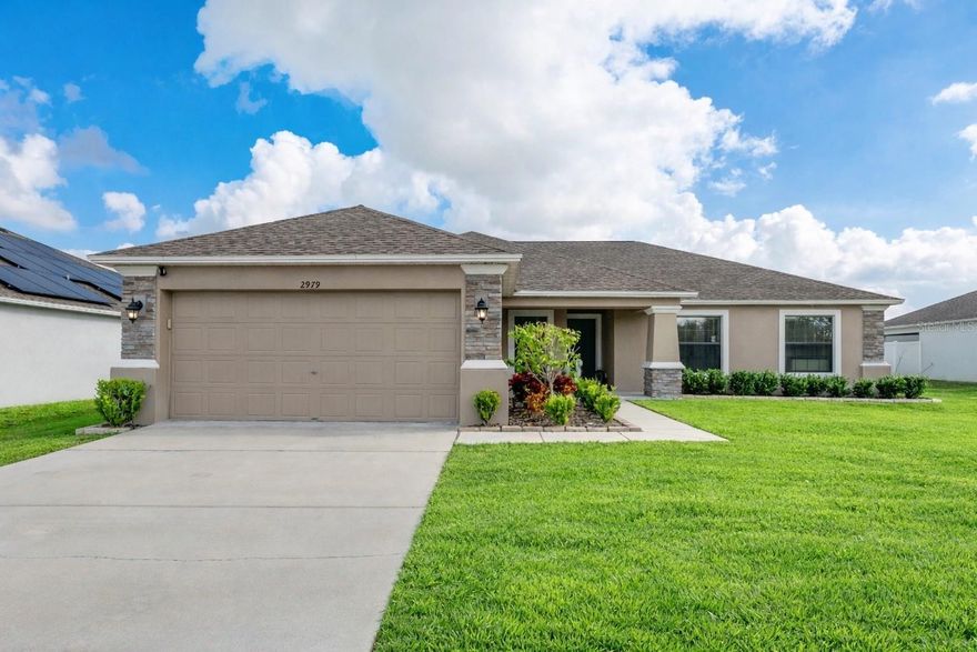 Welcome to this beautifully maintained North Lakeland home, ideally located Linden Trace, a gated community with sidewalks and a neighborhood playground. Built in 2021 by Southern Homes, this Savannah model offers modern design and thoughtful upgrades throughout. Enjoy easy access to local schools, shopping, parks, and recreation, with convenient proximity to Interstate 4 for a seamless commute to Tampa and/ or Orlando. Inside, the open and inviting floor plan features vaulted ceilings, updated molding, and luxury vinyl plank flooring that enhances both style and durability. The kitchen boasts stainless steel appliances with a vent hood, ample cabinet space, and flows effortlessly into both the dining room and breakfast nook, making it ideal for everyday living and entertaining. An indoor laundry room is conveniently located just off the two car garage for added functionality. The split floor plan ensures privacy, with the primary suite serving as a true retreat complete with a massive walk in closet and a well appointed ensuite bath. The home offers three spacious bedrooms and two full bathrooms, along with a flexible den or office that can easily transition into a fourth bedroom. Step outside to a large fenced in yard, perfect for outdoor living, play, or pets. This move in ready home combines comfort, versatility, and an exceptional location in one of North Lakeland’s most convenient communities.
