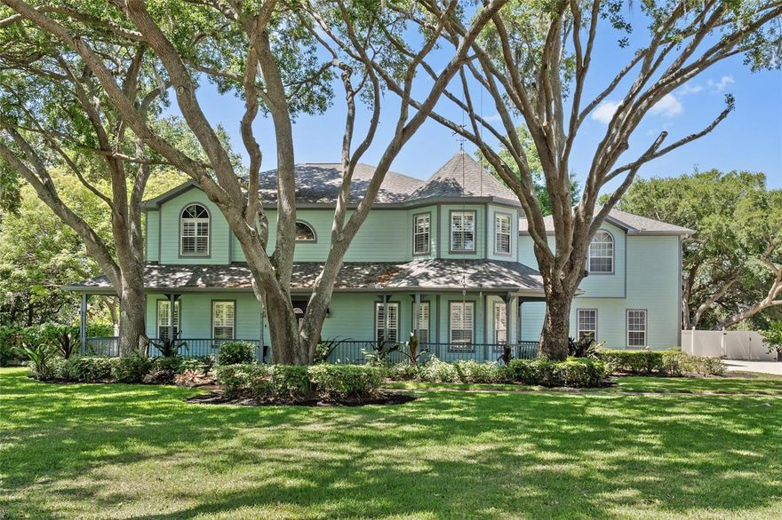 Discover Windermere’s charm and classic style from this stunning Victorian-style pool home, set on a 1-acre lot with no HOA, on one of the most desirable streets. Under the canopy of majestic oaks, this 5-bedroom residence features a dedicated office space and a versatile bonus room ideal for a private apartment or guest suite. A charming wrap-around porch welcomes you into a classic foyer featuring rich wood floors, soaring ceilings, custom millwork, and a graceful grand staircase. Throughout the home, you’ll find exquisite traditional details including dental crown molding, chair rails, and beautifully crafted trim. The spacious formal dining room is filled with natural light and accented by warm wood flooring. The kitchen blends style and function with stainless steel appliances, granite countertops, an island, walk-in pantry, custom cabinetry, and a lovely view of the pool with newly installed screen enclosure. All main living areas are carpet-free, and every bathroom has been thoughtfully updated with travertine flooring, porcelain showers, and marble countertops. The owner’s suite is located upstairs and features bay windows, wood floors, crown molding, and a walk-in closet. Its luxurious bath includes a frameless glass stone shower, dual vanities, and an elegant vessel tub. There’s an added finished and air-conditioned attic playroom above one of the bedrooms for children to explore. Plus the expansive bonus room accessible off the primary bathroom is a spacious and secluded hang out room and offers an optional private entrance leading to the large backyard—complete with a sparkling pool, generous patio space, and room to store a boat. The oversized 3-car garage provides exceptional clearance for larger vehicles, golf carts, and lake toys. Town of Windermere residents have private access available to the Butler Chain via a town boat ramp plus town tennis courts. Home is walking distance to downtown and the weekly farmer’s market, monthly food trucks, and the quaint shopping district.
