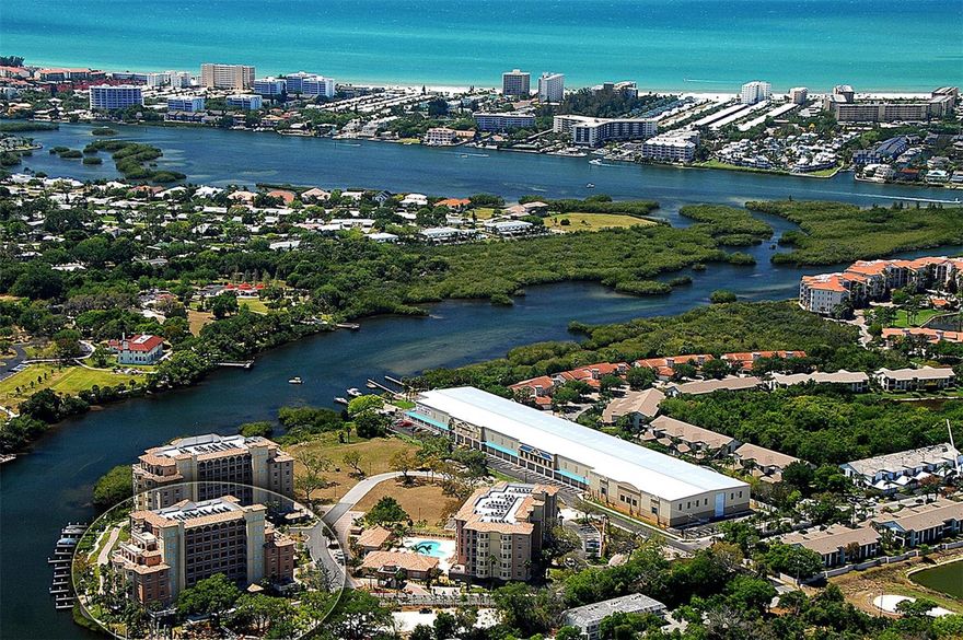INCREDIBLE VALUE - this beautifully remodeled third-floor luxury residence with water view in the gated waterfront community of Phillippi Landings is perfectly situated West of the Trail and just minutes to the world-renowned beaches of Siesta Key. Nestled along the Phillippi Creek with direct access to Sarasota Bay and just minutes to the Philippi Farmhouse market and the Landings Shopping Center with its vast array of dining and shopping options.  This 2 bedroom plus den, 2 bath condo offers the ideal blend of privacy, convenience, and resort-style living. From the moment you enter via direct elevator access to your private foyer entrance, you are welcomed by an open and airy floor plan, porcelain tile flooring, and an inviting coastal aesthetic. The beautifully updated kitchen features granite countertops, stainless appliances, and rich wood cabinetry, offering both style and function for everyday living and entertaining. Step into the spacious living area that opens to a private covered and screened balcony with peaceful water view, ideal for enjoying morning coffee or a glass of wine at sunset. The split-bedroom layout offers exceptional privacy, with two generously sized bedroom suites. The primary suite is a true retreat, offering tranquil water view, two large walk-in closets, and a spa-style bath with a jetted soaking tub, custom walk-in shower, and private water closet. A flexible bonus space off the main living area provides the perfect nook for a home office, den, reading lounge, or secondary dining area. Impact doors and windows throughout.  Beautiful wood plantation shutters. Enjoy the convenience of under-building assigned parking and a private storage unit. This home is move-in ready and ideal as a primary residence, seasonal escape, or investment opportunity. Life at Phillippi Landings is exceptional - the community is 10 acres and offers a resort-style heated pool and spa, a well-equipped fitness center, clubhouse, and an expansive waterfront promenade perfect for evening strolls beneath swaying palms. For boating and nature enthusiasts, the community provides kayak launch access and private storage racks—an invitation to explore the peaceful waterways of Phillippi Creek and beyond. The lush, manicured grounds and tropical landscaping create a tranquil, private atmosphere while placing you just minutes from Southside Village, downtown Sarasota, and the vibrant shopping and dining of UTC Mall. This exceptional location, paired with a refined, low-maintenance lifestyle, offers the best of coastal Florida living.