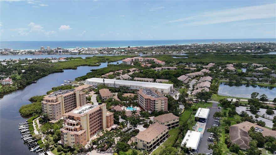 Welcome to 1921 Monte Carlo Drive, Unit 302—a beautifully remodeled third-floor luxury residence with water view in the gated waterfront community of Phillippi Landings, perfectly situated West of the Trail and just minutes to the world-renowned beaches of Siesta Key. Nestled along Phillippi Creek with direct access to Sarasota Bay, this elegant 2 bedroom plus den, 2 bath condo offers the ideal blend of privacy, convenience, and resort-style living. From the moment you enter via direct elevator access to your private foyer entrance, a feature rarely found in condominium living, you are welcomed by an open and airy floor plan, porcelain tile flooring throughout, and an inviting coastal aesthetic. The beautifully updated kitchen features granite countertops, stainless appliances, and rich wood cabinetry, offering both style and function for everyday living and entertaining. Step into the spacious living area that opens to a private covered and screened balcony with peaceful water view, ideal for enjoying morning coffee or a glass of wine at sunset. The split-bedroom layout offers exceptional privacy, with two generously sized bedroom suites. The primary suite is a true retreat, offering tranquil water view, two large walk-in closets, and a spa-style bath with a jetted soaking tub, custom walk-in shower, and private water closet. A flexible bonus space off the main living area provides the perfect nook for a home office, den, reading lounge, or secondary dining area. Impact doors and windows throughout.  Enjoy the convenience of under-building assigned parking and a private storage unit. This home is move-in ready and ideal as a primary residence, seasonal escape, or investment opportunity. Life at Phillippi Landings is exceptional - the community is 10 acres and offers a resort-style heated pool and spa, a well-equipped fitness center, clubhouse, and an expansive waterfront promenade perfect for evening strolls beneath swaying palms. For boating and nature enthusiasts, the community provides kayak launch access and private storage racks—an invitation to explore the peaceful waterways of Phillippi Creek and beyond. The lush, manicured grounds and tropical landscaping create a tranquil, private atmosphere while placing you just minutes from The Landings Shopping Center, Southside Village, downtown Sarasota, and the vibrant shopping and dining of UTC Mall. This exceptional location, paired with a refined, low-maintenance lifestyle, offers the best of coastal Florida living—elegant, easy, and immersed in nature.