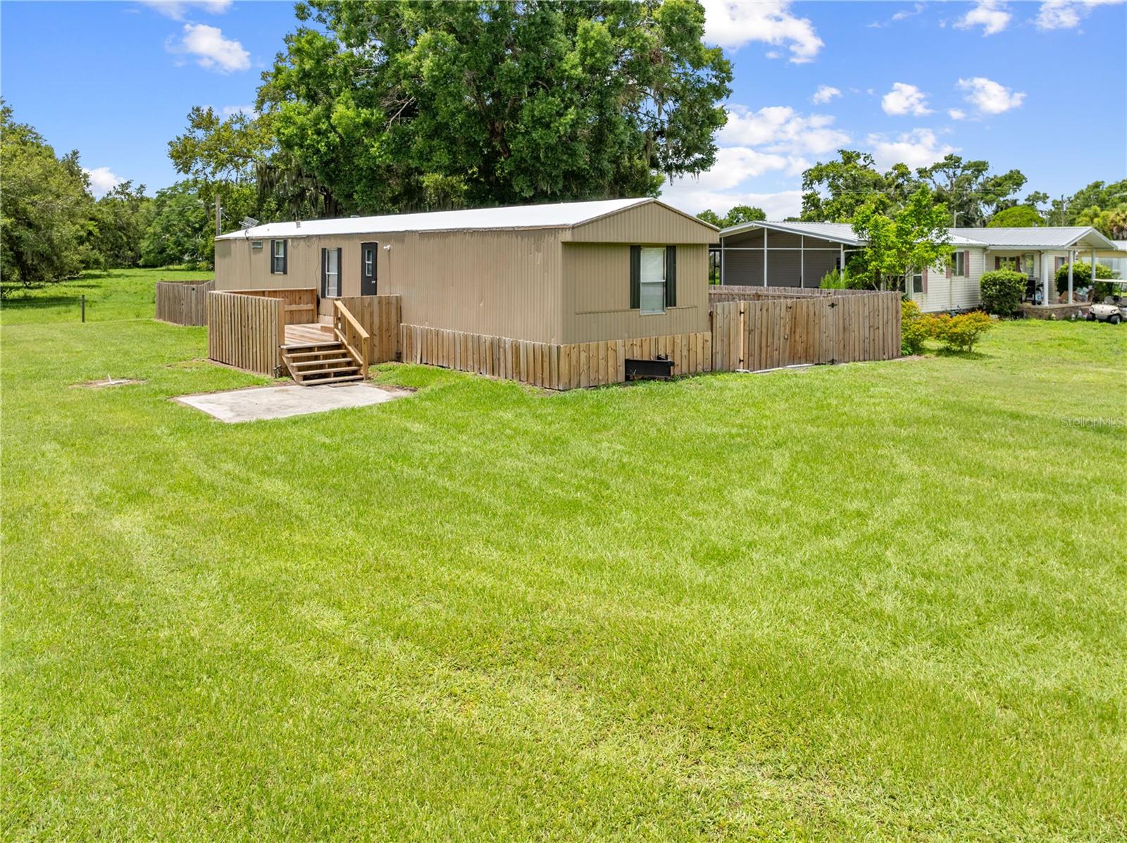 Come see this very well maintained 924 Square Feet, 1986 - 3 Bedroom, 2-bathroom mobile home on over a 1/4 of an acre. This spacious, very functionally laid out mobile home has a large Kitchen and Living space. A split floorplan with one bedroom and a bathroom with a large garden tub on one end, and 2 bedrooms that share a jack-and-Jill style full bathroom with a shower, and an inside laundry area on the other end.
Enjoy a fully fenced backyard with wooded views, a new carport over a concrete pad that doubles as a perfect grilling or hangout space, with plenty of shade for relaxing afternoons. Located in peaceful Kenansville, south of the growing town of St. Cloud, with convenient access to local essentials, dining, and outdoor recreation. The property is less than a mile from the public boat ramp to Lake Marian—a spring-fed, 6,000-acre lake renowned as one of Florida’s best Crappie fishing destinations, according to the Florida Freshwater Commission. Centrally located – just 35 mins to St. Cloud, 45 mins to Melbourne, and only 1 hour to Vero Beach or Orlando!
Whether you're a seasonal angler or just looking to escape the city, this peaceful retreat offers the best of both worlds. Affordable, spacious, and move-in ready!