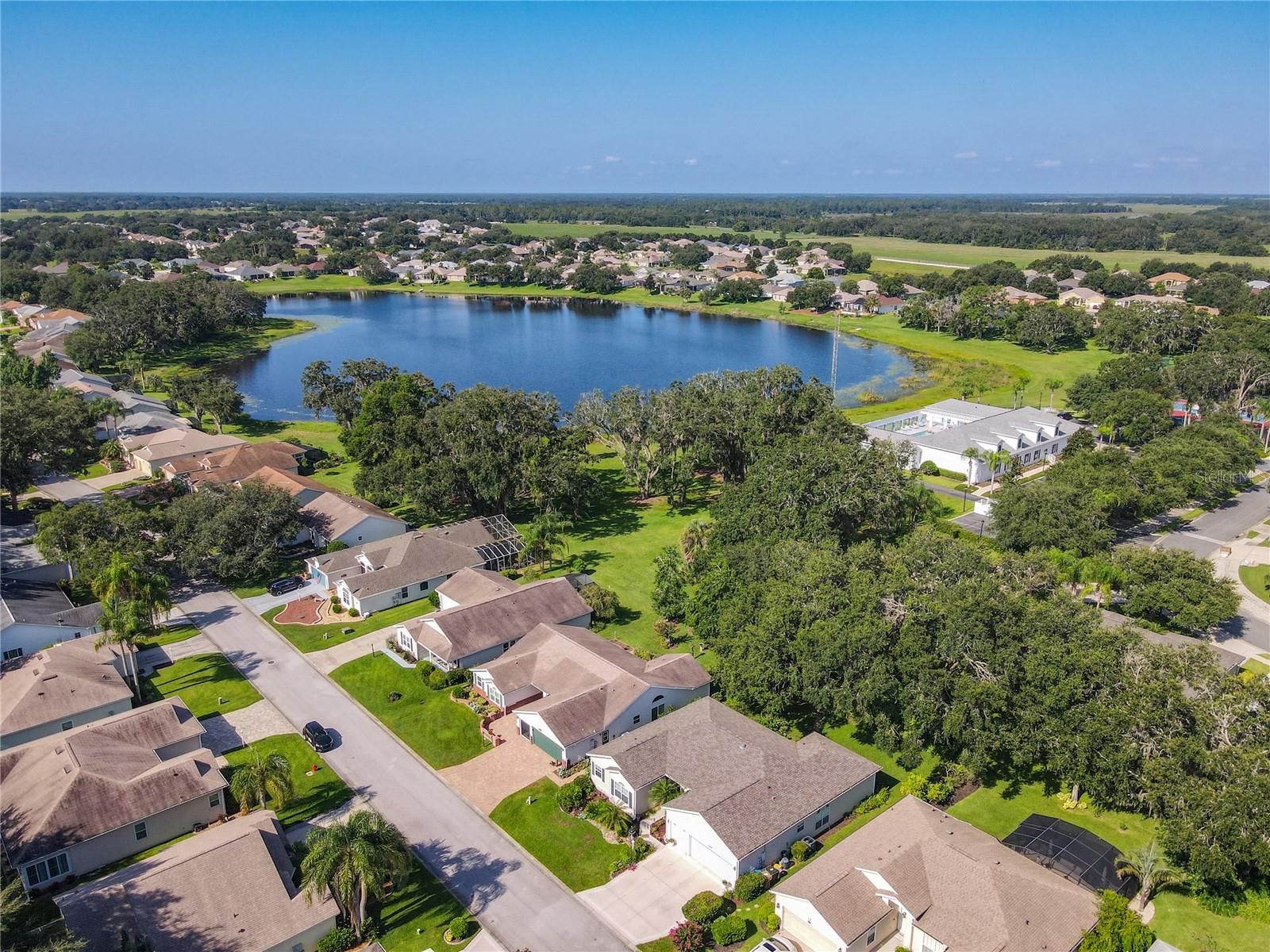 PRICE IMPROVEMENT! SELLER MOTIVATED! Welcome Home to Comfort, Privacy, and Endless Amenities! This beautifully updated private residence is designed for both relaxation and entertaining. Featuring two spacious Master Suites, a third versatile bedroom, and a large two-car plus golf cart garage, this home offers exceptional value in one of Leesburg’s most sought-after 55+ communities—The Plantation at Leesburg. New Roof (2020), High-Efficiency HVAC System (2021), Remodeled Bathrooms (2023), Expansive Enclosed Lanai – Under air and heat, with a mounted TV and direct access via French doors from both the Living Room and Master Suite Infrared Sauna & Spa – Negotiable! Hydroponic Equipment – Negotiable! Spacious Living : Primary Master Suite: Room for a reading nook, huge walk-in closet (three-tier shelving), spa-like bath with dual vanities, deep soaking tub, and a tiled walk-in glass shower. Secondary Master Suite: Perfect for guests or multi-generational living with private bath and lanai access—ideal after enjoying the sauna or spa. Third Bedroom: Excellent as a guest room, art studio, or home office. Pocket Doors separate the Kitchen from the Dining & Living Rooms for added privacy. Solar Tube brightens the kitchen naturally. Family Room: Versatile space currently used as a fitness area—Treadmill included! (Other equipment negotiable) Whole-House Zoned Audio System – Included! Two-car garage with additional golf cart space Pull-down attic stairs with storage above. Abundant closet space throughout. Enjoy your own orange and lime trees. Retractable awnings for shade. Magical views of lake while you are working on your BBQ and wildlife. Easy access to walking trails and the community center. The Plantation at Leesburg A 24/7 gated, manned security community offering:3 Activity Centers with heated pools, spas, and fitness centers, 2 18-Hole Golf Courses with Pro Shop, Driving Range, and Restaurant & Tavern, Tennis & Pickleball Courts, Shuffleboard, Softball, Bocce Ball, Horseshoe, Archery Field, Woodworking Shop, Train Club, Art Club, Library, RV/Boat Storage Available. Over 100 planned activities every week. Enjoy scenic boulevards, lush landscaping, tranquil ponds, and walking trails—an idyllic setting for your next chapter.