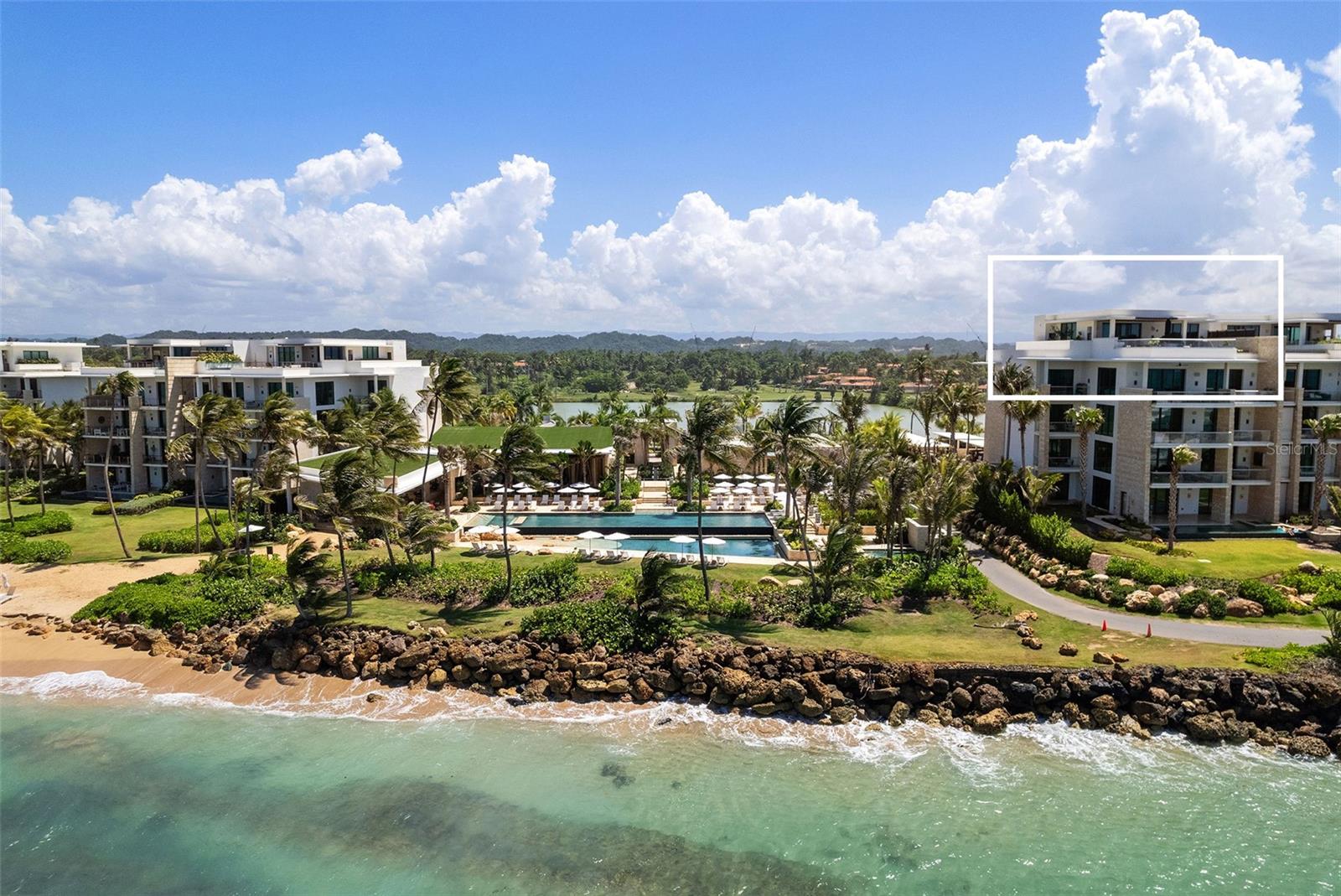Experience the epitome of luxury oceanfront living at this newly built West Point Penthouse, part of the Ritz-Carlton Residences nestled within the esteemed Dorado Beach Resort and Club. This exceptional two-story penthouse boasts unrivaled ocean, sunrise and sunset views, providing sweeping 360 panoramas of one of the world’s most picturesque beaches, majestic coral reefs, and lush mountain ranges. This penthouse enjoys the Dorado Beach Resort’s most privileged location, adjacent to the West Point Beach Club, and boasting uniquely protected and unobstructed views of Puerto Rico’s northern coastline.
Featuring four bedrooms, including a master suite and junior suite on the first floor, this penthouse offers a unique blend of comfort and understated elegance. The third south facing bedroom provides captivating views of the Resort's newly redesigned Robert Trent Jones Jr. TPC West Course as well as the lake and lush mountain regions. With approximately 4,265 square feet of interior air conditioned space and a total gross area of 7,172 square feet, there's ample room for entertainment, especially on the expansive first floor and rooftop terraces.
Enjoy the convenience of a separate covered stair entrance for direct access to the rooftop, ensuring privacy for living areas while
entertaining. Inside, an elevator or interior stairs can take you to the upstairs living area, complete with a living room, full bathroom, wet bar, and additional on-suite bedroom boasting breathtaking oceanfront views, presently utilized as an elegant home office.
Prepare your culinary masterpieces in a kitchen designed to inspire, with the added delight of direct ocean views while you cook and entertain. Equipped with top-of-the-line appliances such as a 36' Sub-Zero refrigerator, Wolf induction cooktop, two ice makers, two Sub-Zero wine fridges, and reverse osmosis water filters throughout, this chef's haven caters to your every need. Custom Neolith Calacatta Gold matte finish countertops, island, and backsplash, complemented by Poliform open shelving and a built-in plaster finished hood, elevate the space to new heights of sophistication. Whether hosting lively gatherings or intimate dinners, the dining and living area offer a warm and welcoming ambiance for all occasions.
Cutting-edge audiovisual technology, security system, custom built electric shades, and Lutron lighting is integrated throughout the unit, complemented by luxurious upgrades including matte fixtures for a contemporary touch. Featuring cathedral ceiling heights throughout the living and entertainment areas, the penthouse emanates a sense of grandeur and spaciousness. Step outside to the rooftop covered terrace, where an outdoor kitchen, built in Wolf grill BBQ area, wet bar, pool, and jacuzzi await, creating an idyllic setting to soak in the breathtaking views and coastal ambiance.
Comfort meets luxury with convenient access to the new exclusive West Point Beach Club with pools, jacuzzi, saunas, steam rooms and cold plunge. This West Point Penthouse is also steps from world class surfing, ocean sports, and snorkeling areas. This residence comes with three covered golf cart parking spaces, an air conditioned double car garage, and a large additional storage or parking space. Immerse yourself in the pinnacle of coastal oceanfront living at Dorado Beach Resort and Club with this unparalleled penthouse residence.