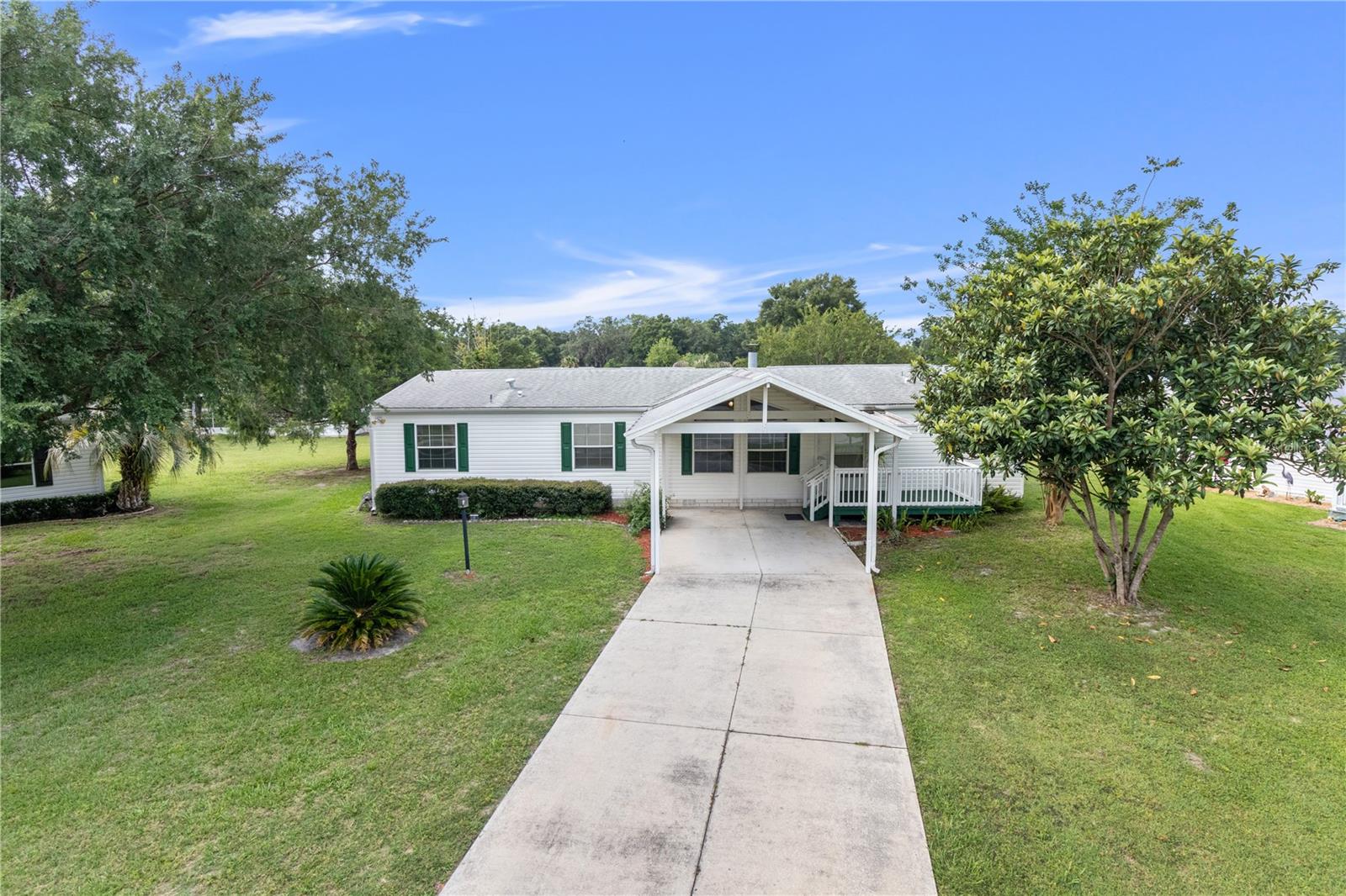 What a perfect place to call HOME! Welcome to the Falls of Ocala- a 55+ community where you own your own .18 acre lot! Gorgeous luxury vinyl plank floors, fresh interior paint, newer light fixtures and fans, a 2019 roof, air duct cleaning, and a pressure wash make for easy living in The Falls. Turn into your neighborhood, greeted by a waterfall- views of quintessential Ocala farmland across the street. The landscaped entry with waterfall & large Oaks on a paved road makes for simple accessibility to your new home. Your spacious and well-kept home sits on a cul-de-sac with concrete parking under an oversized carport out front. Step inside to a split floor plan; 1,800 square feet of open-concept living space, high ceilings, and a wood-burning fireplace. The primary bedroom is to your right, can easily fit a King-sized bed, and boasts a 12x9 bonus space/ office room. Set up your craft room, work from home, or tinker under AC here! Double sinks, a separate bath tub, and a huge walk-in closet make this space inviting. The kitchen sits at the center of the home and opens to the dining room and living room; 2 equally-sized guest bedrooms, and an indoor laundry room to your left. There are 3 outdoor spaces sitting on concrete- a screened-in porch to relax, a place to grill/garden, and an enclosed shed with electricity! Low HOA of $200 a month includes yard mowing & maintenance, water, sewer, use of community pool, sauna, clubhouse with exercise room, game area/ shuffleboards/ fire pit. Plus, the Boat & RV yard is located near the clubhouse. Utilities include SECO electric company & Spectrum Internet. Located just off State Road 40, across the street from green pastures, located near the Ocala Airport, minutes from I-75, State Road 200, and the World Equestrian Center. BIG VALUE and EASY LIVING so close to everything- move right in and start having fun in Florida!