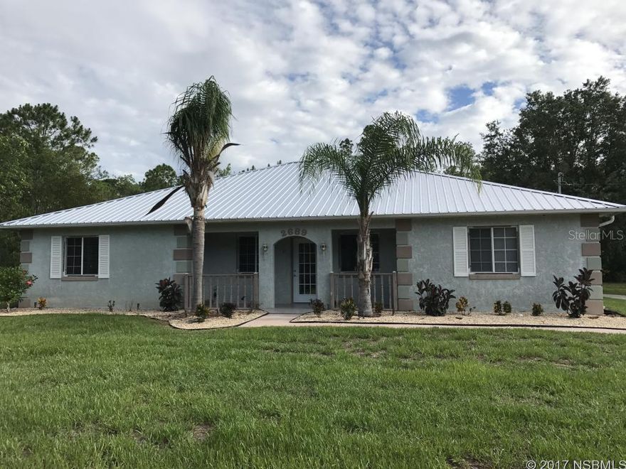 This Beautiful split plan home is on 2.5 acres of privacy yet is only minutes to shopping, dining and New Smyrna's famous beach.  Bring your toys or equipment & enjoy this Meticulously maintained and updated move in ready home providing all the amenities you expect in the private, easy access location you desire.  Enjoy problem free living for years to come as updates include a New Metal Roof, New Air Conditioning, New Stainless Steel appliances in an updated kitchen with beautiful granite counters.  Tile and hardwood floors, New Blinds throughout, New light fixtures an updated water treatment system that softens and filters has also been added to service the home.  The home also offers a rear entry 2 car garage and a 4th room with private entrance that would be an excellent office space or extra room to support your lifestyle.  Make an appointment today to see this beautiful home!