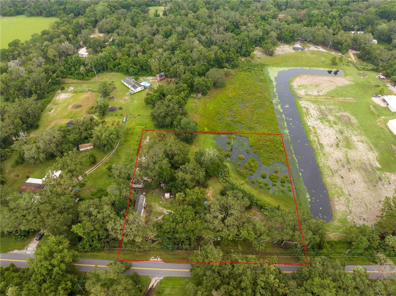 Discover this beautiful 2.17-acre property in Central Florida—perfect for nature lovers and those seeking space and serenity. Surrounded by mature trees and peaceful scenery, it’s just 21 miles from The Villages and about an hour from Orlando, Daytona Beach, and top attractions like Disney. The property comes ready with an artesian well, electricity, and running water, and is suitable for a manufactured or pre-fabricated home. A new 2024, 2-bedroom 2 bathrooms, mobile home offers a move-in-ready option while you plan your dream build. Enjoy ample storage with two sheds, ideal for a workshop, kid's playroom or anything you can put your imagination to! Tucked near the scenic Harris Chain of Lakes, with access to charming towns like Tavares, Mount Dora, and Leesburg, this location combines natural beauty with everyday convenience. Don’t miss this rare opportunity—schedule your showing today!