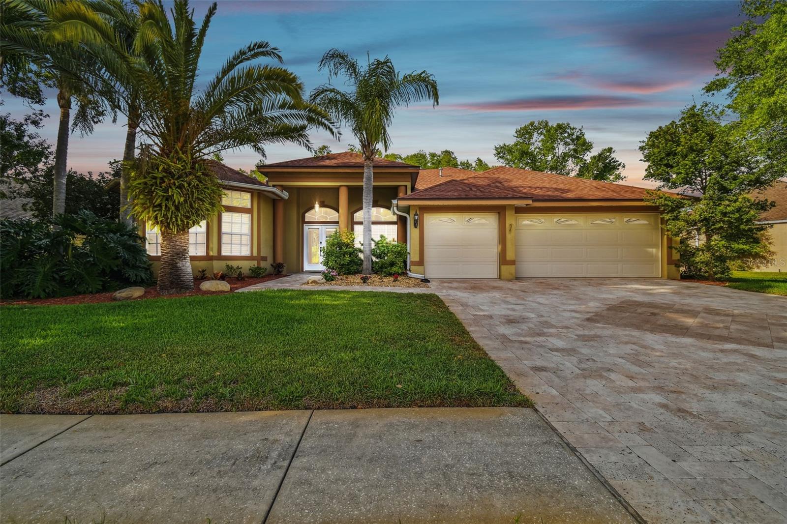 Tucked in one of Palm Harbor's most desirable communities of Lansbrook is this impressive 4 Bedroom, 3 Bath, Pool & Spa home on an oversized Lot on Conservation in Fallbrook! A beautifully paved Travertine Tile driveway & walkway welcomes you to a large porch and double door entry. Once inside you'll notice a seamless flooroplan with lots of windows and natural sunlight. Enter to a formal dining room and living room with sliders to the backyard. Triple split plan with a good sized primary bedroom with a sitting area & bathroom to your left that boasts double walk-in closets, tastefully updated with double sinks, a sunken tub, and walk-in shower. Beautifully updated kitchen with wood cabinets, stainless appliances, breakfast bar and plelnty of storage. This area has lots of windows and opens to the dining area/breakfast nook and a large family room. Three additional good sized bedrooms, and two full bathrooms. Enjoy no rear neighbors in the backyard that feautres a pool and spa with diamond brite finish and beautiful travertine pavers. You'll get plenty of wildlife passing by too! This home features solar panels that will keep your monthly electric bills low!! Lansbrook is a great place to call home and has 2 community parks with playground, ball fields, basketball courts and a place to launch your boat. This is a great opportunity to live in a lovely pool home on a great lot! This home has Solar panels and they are paid for.