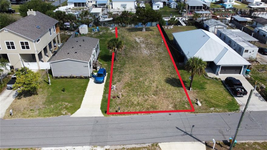 One or more photo(s) has been virtually staged. Tucked between the laid-back charm of New Smyrna Beach and the energy of Cape Canaveral, this 50x176 deep-water canal lot in Oak Hill offers a rare opportunity to build the waterfront lifestyle you have been envisioning, at an attainable price point. With direct access to the Intracoastal Waterway and the world-renowned Mosquito Lagoon. The canal accommodates a 24-foot center console, sailboat, or pontoon boat, and has an existing concrete seawall already in place. New canals are no longer being cut in Florida, making established canal-front lots like this one increasingly scarce and valuable. The lot sits above sea level with no flood concerns, and there is no HOA to limit your vision.

Everything you need to break ground is already in place: impact fees are paid, and public water, sewer, and electric are connected and ready. Engineered and sealed house plans by a licensed Florida professional engineer are available for a thoughtfully designed 3-bedroom, 2-bath home featuring 1,652 square feet under air, a 2-car garage, and a board-and-batten/stucco exterior on CMU construction. Zoned MH-5, which permits both manufactured and site-built homes. The city allows an RV on-site while your new home is under construction, so you can be present for the build without sacrificing comfort. New homes are already rising in the neighborhood, making now the right time to secure your place on the water.

Please note: select listing photos are AI-generated conceptual renderings created to illustrate the potential of this lot with a completed home and pool; they are not photographs of existing structures.