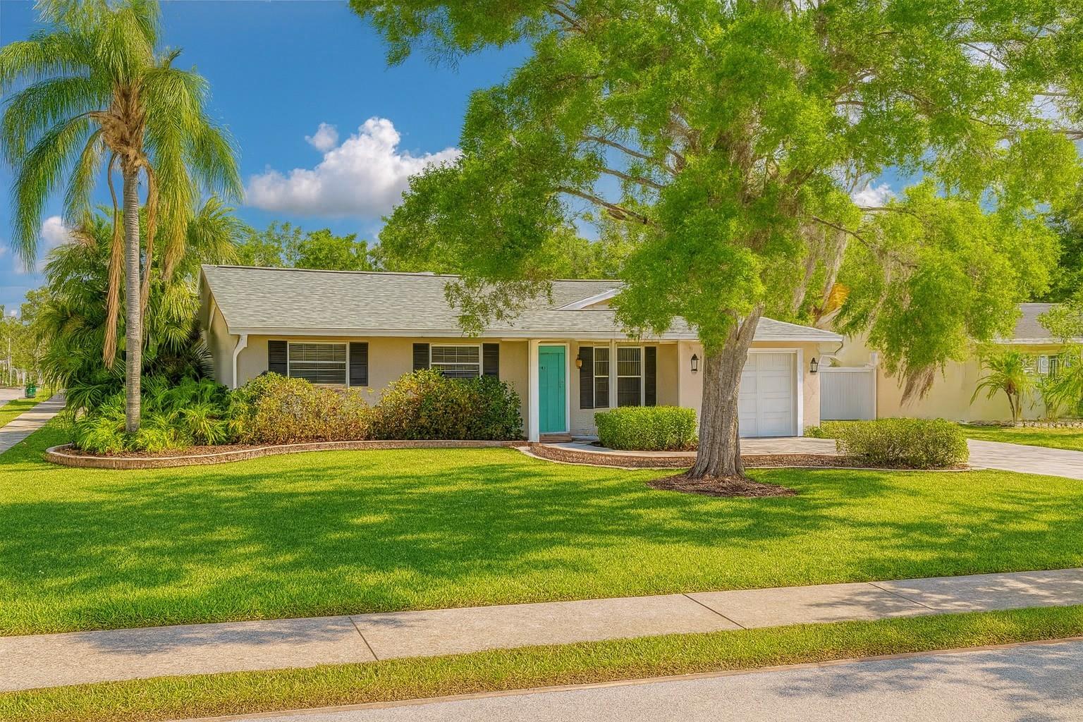 Located in the highly sought-after Palm Harbor School District, this FOUR-bedroom POOL home offers the perfect blend of comfort, style, and functionality. Enter through the screened entryway into a versatile bonus room, ideal for a home office, playroom, or second living space. The newly updated kitchen features stainless steel appliances, a spacious layout, and a large walk-in pantry, flowing into a generous eat-in dining area. The open-concept design continues into the large living room with new flooring, a striking wood ceiling, and an additional flex space overlooking the pool—perfect for relaxing or entertaining. The primary suite offers a cozy window nook, ample closet, and an extended sitting area—perfect for a desk, reading corner, or Peloton setup—along with a private ensuite bath. The secondary bedrooms are located just down the hall and share a full bathroom, ideal for family or guests. An interior laundry room provides added convenience and connects directly to the attached garage for easy access. Step outside to your own backyard oasis—featuring a screened SALTWATER pool, a spacious paver patio and a fully fenced CORNER lot. The extended driveway includes a parking pad for your RV or boat. Additional updates include a NEWER ROOF (2021), fresh interior paint and BRAND NEW FLOORING in the living areas. Located just steps from downtown Palm Harbor’s restaurants, festivals, and the Jolly Trolley, with easy commutes to Clearwater Beach and both local airports—this home truly has it all! Some photos have been virtually staged to show potential use of space.