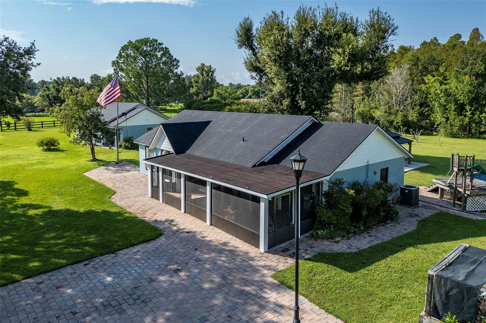 Two New Roofs, New AC, and Two Homes on 3.6 Acres – Endless Possibilities Await! Freshly updated and move-in ready, this rare multi-home property at the quiet end of Stetson Drive offers the best of both worlds—peaceful country living with modern comforts just minutes from town. Situated on 3.6 acres, zoned agricultural, and surrounded by the protected Green Swamp, it’s a private retreat with room to bring your vision to life. The main home features a new roof and a brand-new AC system, along with four spacious bedrooms, two bathrooms, and rich hardwood floors that flow through the main living areas. French doors lead to a tranquil outdoor patio, while the screened-in front porch is perfect for sipping morning coffee or unwinding at the end of the day. Fully move-in ready, it comes complete with all appliances and a convenient indoor laundry room. The second home also has a new roof and is a charming two-bedroom, one-bath retreat with its own indoor laundry, private entrance, and screened back porch accessed through elegant French doors. It’s ideal for extended family, rental income, or a private workspace, and pre-approved plans to enclose the carport provide even more opportunity to expand. Underground power, an air-conditioned shed or office, a 50-amp camper hookup, and included mineral rights from State Road 33 down Stetson Drive add to the property’s value and convenience. Despite its quiet, rural feel, you’re only ten minutes from Groveland and just thirty minutes from Disney, Lakeland, and Kissimmee. Adventure lovers will enjoy nearby Seminole Lake Gliderport and Revolution Off-Road Park. Whether you envision planting fruit trees, starting a hobby farm, or simply enjoying wide open space with room to grow, this property is ready to make it happen. Opportunities like this don’t come around often—schedule your private showing today.