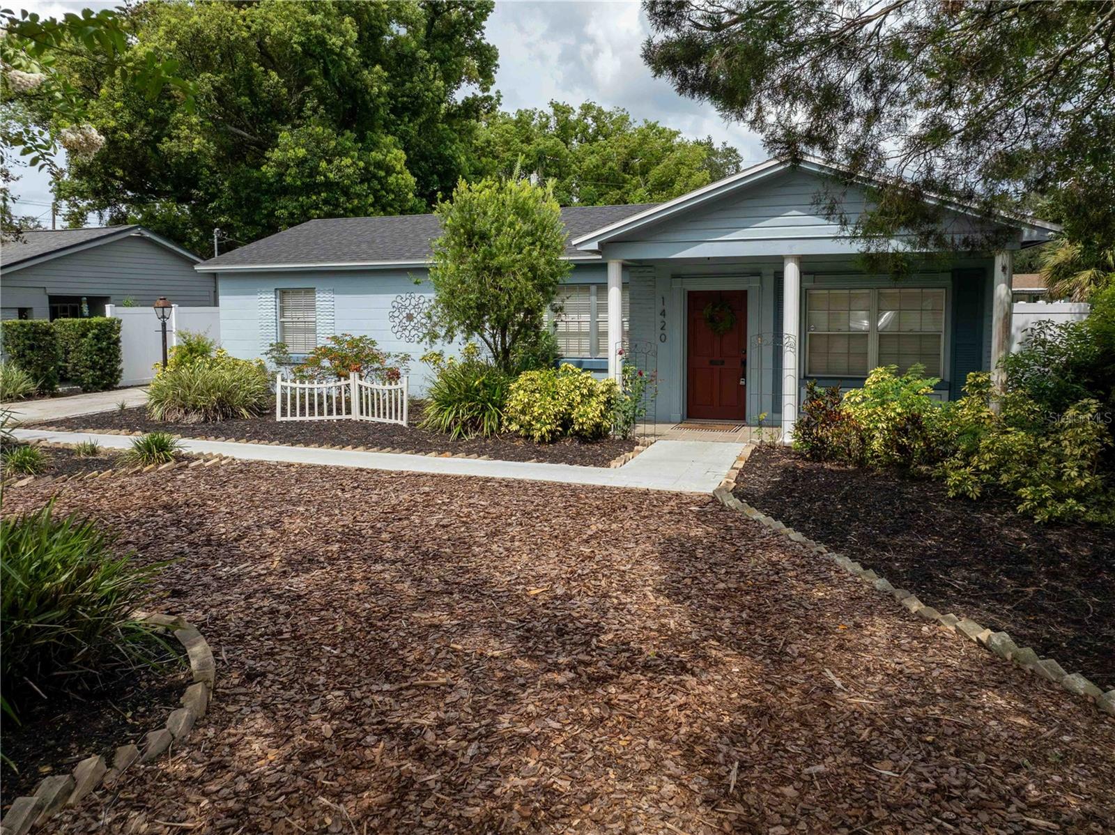 Welcome to Camphor Heights, one of Lakeland’s most loved neighborhoods and the perfect spot for your next home! This 3 bedroom, 2 bath beauty is full of charm, updates, and a few surprises that make it stand out from the rest.
From the moment you pull up the long driveway and step onto the welcoming front patio, you’ll feel right at home. Inside, natural light pours through the big windows into a spacious living and dining combo, while the Florida room with built-ins is just begging to be your favorite hangout whether you’re curling up with a book, hosting friends, or soaking in the view.
The kitchen brings it all together with wood cabinets, tons of counter space, a double oven, and brand new appliances (yep, refrigerator & dishwasher). There’s even a pass-through window into the Florida room so you can stay connected while entertaining.
The primary suite is something special with soaring ceilings, exposed beams, dual closets, and a bonus flex space that’s currently a nursery but would also make an amazing office or cozy retreat. The en suite bath has double sinks and a walk-in shower. Two more bedrooms share a stylish hall bath, and the family room (yes, there are two living spaces!) also features exposed beams for that warm, character-filled feel.
Step out back and you’ll find your private, fenced-in yard with mature landscaping. And here’s the showstopper: a detached shed, half finished. Translation? Instant flex space. Home office, MIL suite, man cave, she shed, you name it, this space is ready for it.
Other perks include a new roof, updated vinyl plank flooring, fresh landscaping, and a bright interior laundry with storage.
And let’s not forget location. You’re minutes from Lake Hollingsworth, Downtown Lakeland, Dobbins Park, Common Ground, and Lakeside Village. Everything you need is close by, but you still get the quiet, tucked-away vibe that makes Camphor Heights so loved.
This home is friendly, flexible, and ready for its next story. Maybe yours?