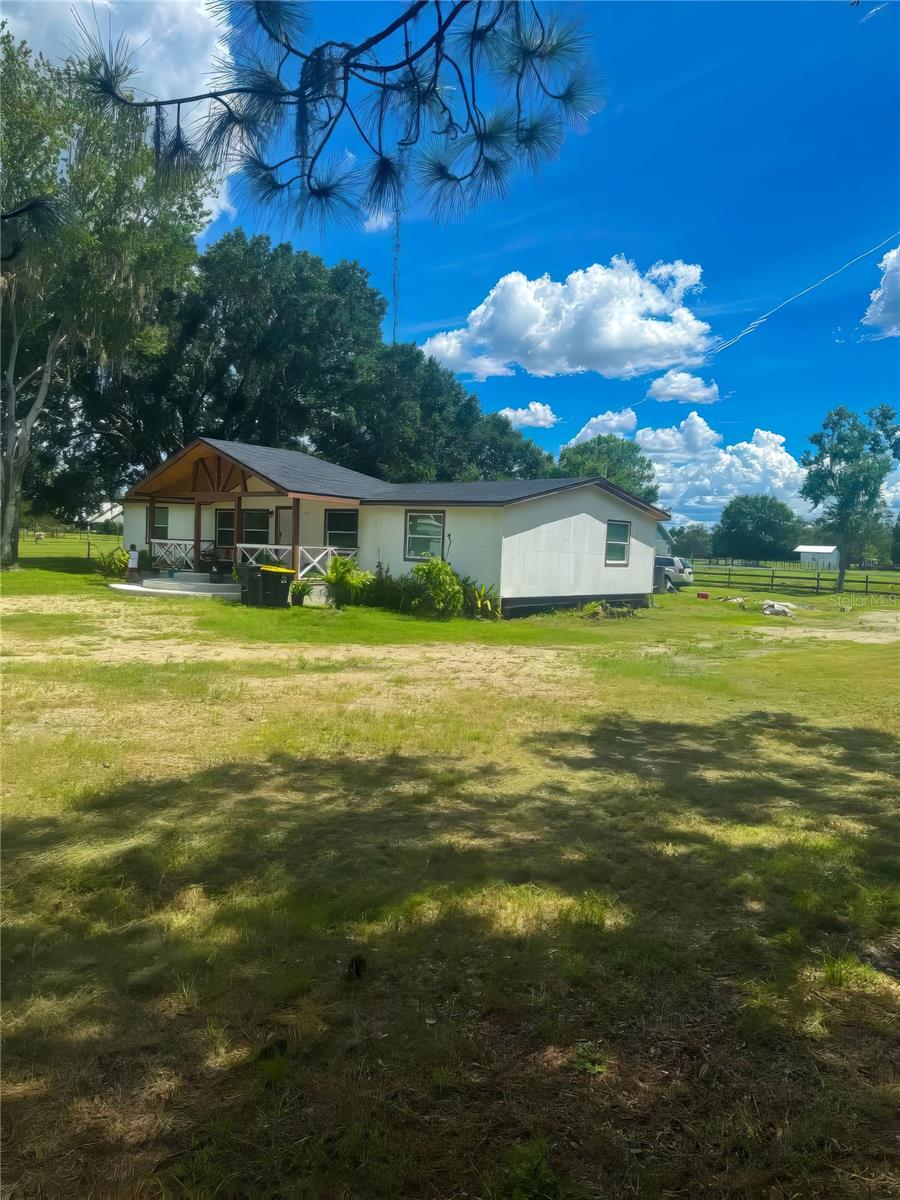 Escape to your own private retreat just 30 minutes from Disney! Nestled on a sprawling 10-acre lot, this beautifully updated 4-bedroom, 2-bathroom home offers the perfect blend of peaceful country living and modern convenience. The property features a fully remodeled double-wide mobile home, ideal for families or investors looking for a successful short-term rental—currently operating on Airbnb. Bring your animals, outdoor toys, and sense of adventure—there’s plenty of space to roam. The land is partially fenced, with a well and septic system in excellent condition. Enjoy relaxing evenings in the hot tub on the spacious backyard deck, surrounded by nature and tranquility. Whether you're seeking a permanent home, vacation getaway, or income-producing property, this is a rare opportunity you don't want to miss. Contact us today to schedule your private tour and discover the charm of Central Florida country living!