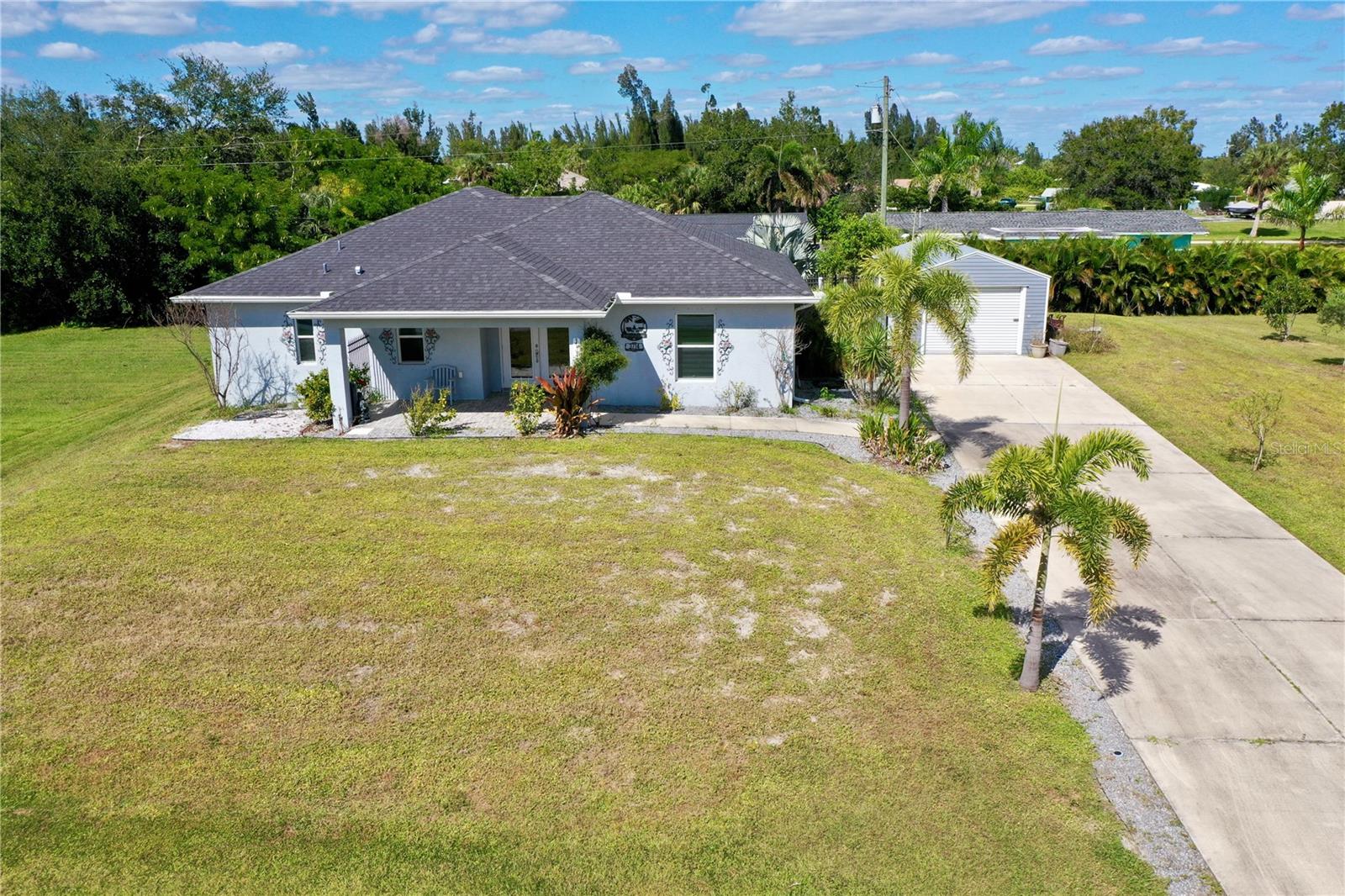 Welcome to Your Punta Gorda Paradise! Experience the perfect blend of comfort, elegance, and Florida living in this beautifully designed 2-bedroom, 2-bathroom home spanning 1,400 square feet. Built in 2019 on a triple lot (18,021 sq ft total), this property offers the space, privacy, and peace of mind you’ve been searching for. Perched on high ground and untouched by the storms of 2024, this home delivers both security and serenity in one of Punta Gorda’s most sought-after settings. Step inside and be greeted by vaulted ceilings, stylish tile flooring throughout, and fixtures that exude modern sophistication. The open-concept layout creates a light and airy flow, enhanced by hurricane-impact windows that invite an abundance of natural light while keeping you safe and sound. The spacious primary suite is your personal retreat—featuring sliding doors that open to the oversized, screened-in lanai where you can unwind and enjoy the evening breeze. The luxurious ensuite bath includes a dual-entry walk-in shower with Dual showerheads for a spa-like experience. Entertain or relax in the expansive screened and covered lanai, complete with beautiful tile flooring and accessible through triple sliding glass doors. This seamless indoor-outdoor connection is perfect for gatherings, alfresco dining, or simply soaking up the Florida sunshine in total privacy. An irrigation system that can keep your lush landscaping in pristine condition year-round. Location couldn’t be better — just minutes from downtown Punta Gorda’s charming shops, fine dining, and waterfront activities. Travel is effortless with Punta Gorda Airport only 5 minutes away, and Southwest Florida International Airport (RSW) in Fort Myers just a 40-minute drive. Quick access to I-75 makes exploring all of Florida a breeze. Love the outdoors? The Darst Boat Ramp is right down the street, offering easy access to Charlotte Harbor and the Gulf of Mexico, and golf enthusiasts will enjoy a different course for every day of the week within 30 minutes. This home truly offers it all — luxury, safety, and an unbeatable location — making it one of the most desirable finds in Punta Gorda. Don’t miss the chance to make this remarkable property your forever home or seasonal retreat!