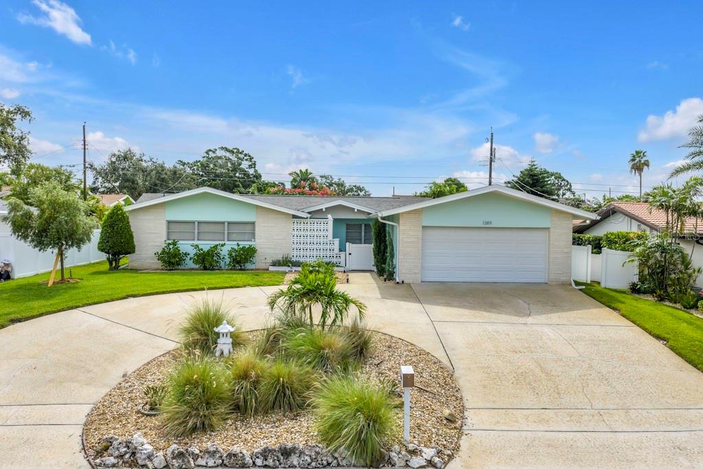 MID-CENTURY MODERN STYLE WITH TRUE RETRO VIBES! Located in the sought-after, high and dry community of Harbor Hills (Flood Zone X – no flood insurance required), this 3-bedroom, 2.5-bath, 2-car garage home offers nearly 2,000 sq ft of classic charm with thoughtful modern updates. From the moment you step inside, you'll appreciate the open, inviting layout and the unmistakable retro flair throughout.
Enjoy polished terrazzo floors, a split bedroom plan, and a spacious flow perfect for entertaining or relaxing. The kitchen is a showstopper – featuring Big Chill aqua retro appliances, including the refrigerator and dishwasher, an oversized Italian chef’s stove, and custom high-definition printed Boomerang countertops that tie the look together beautifully. As a bonus, the home includes a 403 sq ft Florida room, offering the perfect extension of your living space for hosting or unwinding. The laundry area and additional half bath (sink and shower) are located in the garage for added convenience. Both the living and dining areas open to the Florida room, creating flexible spaces to fit your lifestyle. This home delivers timeless design, a fun retro aesthetic, and solid updates—all in an ideal Largo location. Come experience the perfect blend of nostalgia and comfort! FEATURES TO NOTE: NEW SHINGLE ROOF JUNE 2025, NEW FLAT ROOF 2024, NEW HVAC JUNE 2025, SELLER TO PROVIDE CLEAN 4 POINT INSPECTION REPORT TO BUYER