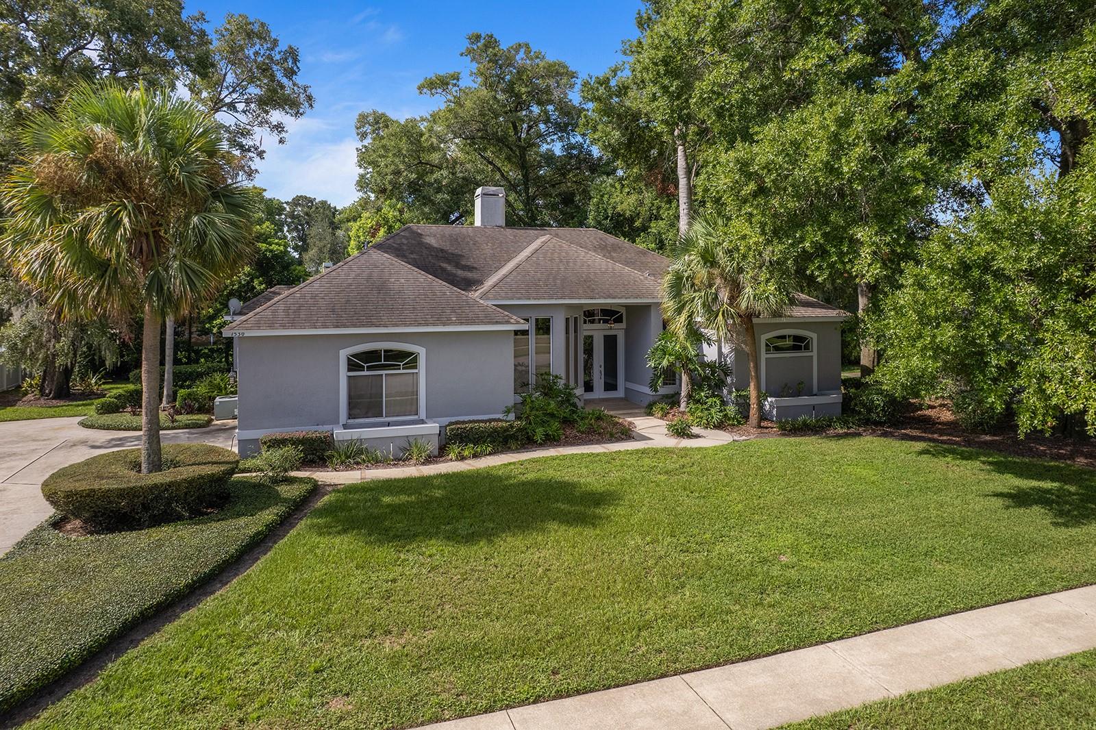 Located in the established Cross Creek neighborhood of DeLand, this three-bedroom, two-bath residence has been thoughtfully and tastefully renovated for modern living. The home is situated on a cul-de-sac street, providing privacy and minimal traffic, while its one-third acre lot offers ample outdoor space.
Inside, wood floors extend throughout the residence, creating a cohesive and warm aesthetic. The updated kitchen features a blend of shaker-style cabinetry and open shelving, complemented by quartz countertops and an island with seating. A tray ceiling adds architectural detail above, while the electric cooktop and wall oven/microwave combination provide functionality for cooking and entertaining.
The split-bedroom layout places the primary suite on the western side of the home, while the two additional bedrooms are located on the eastern side, offering separation and comfort. The two-sided wood-burning fireplace is located between the dining room and the kitchen and is highlighted by beautiful stone.
Additional highlights include a side-entry two-car garage with an extended driveway, accommodating multiple vehicles, and a cozy backyard with potential for outdoor living enhancements. The screened rear patio overlooks the mature landscaped yard.
This property offers convenience as it is just nine minutes from the historic downtown DeLand, known for its shops and dining, and close to the acclaimed Stetson University.