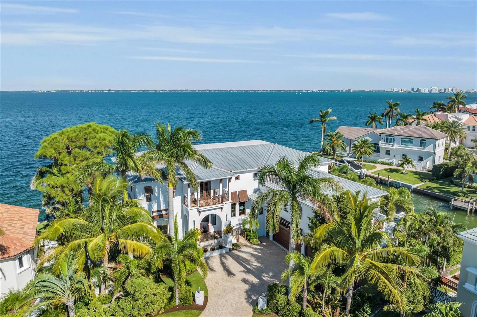 Discover the ultimate waterfront luxury at 620 Yardarm Lane, Longboat Key. This custom-built masterpiece by John Cannon Homes offers a sprawling 7,200 sqft of coastal elegance offering a FULL BAY VIEW that will take your breath away on the preferred south side of the street.
Situated in one of Longboat keys most prestigious neighborhoods with private deeded beach access, bike to St Armand's Circle & a short drive to downtown.
As you enter this sophisticated coastal residence, a floating staircase welcomes you, setting the tone for the grandeur that awaits with 11-foot coffered ceilings. The attention to detail is evident throughout, with wide plank Hickory flooring that adds warmth and sophistication.
There is a beautifully appointed luxurious principal suite on the first floor, providing easy access and privacy.
The open floor plan flows seamlessly connecting living spaces making it perfect for relaxation and entertainment with
a wall of custom 10’ sliding pocket doors a fireplace with a custom stone mantle & 2 Capiz shell chandeliers.
In the sitting room, innovation takes center stage with a hydraulic lift for the television, ensuring uninterrupted bay views when not in use. Imagine gazing out at the water’s edge with the touch of a button.
The gourmet kitchen includes an oversized Sub-Zero refrigerator, Wolf range & Carrara marble counter tops.
A separate butlers pantry boasts convenience and style, featuring a Sub-Zero wine cooler & ice machine, Wolf warming drawer & an additional refrigerator & sink. Entertaining is a breeze with this well-appointed space.
Beyond the kitchen is an elevator & a secondary staircase, leading you to a mezzanine floor, comprising a spacious office & game room with a wet bar. There is even a secret door leading to a large movie room—a hidden gem for film enthusiasts.
Leading off from the living room is a terrace showcasing a true outdoor oasis, complete with sitting & dining areas and an outdoor fireplace, all thoughtfully protected from insects by an electrically operated drop-down screen. It’s the perfect place to unwind, or dine, while taking in the serene bay vistas.
The outdoor area continues with an infinity edge pool & spa, where you can enjoy beautiful sunrises and spend the day soaking in the serenity of the bay. Picture yourself basking in the sun-drenched pool or enjoying evenings by the water feature-fire pit, all under the backdrop of the beautiful views of Sarasota Bay & Downtown.
Other outdoor areas feature a built in Wolf gas grill & an outdoor shower plus multiple areas to sit or lounge while enjoying the warm Florida sunshine.
On the second floor, discover four large ensuite bedrooms, each with balconies, plus a bonus children's room with built in bunks. Stay fit in the gym area and then step onto the large adjoining balcony with a full-size hanging bed and a spectacular panoramic bay view.
The house features an extra-large three-car garage with ample storage areas and a full house generator.
For the boating enthusiast this house offers both bay front & canal frontage. The large dock includes two boat lifts, a pair of jet ski lifts, kayak lift plus guest boat docking & a new seawall, this completes the picture of waterfront living.
620 Yardarm Lane, Longboat Key, is not just a home, it’s a lifestyle: it's a haven of luxury and surprises. Come, experience the quintessence of Florida living at its finest.