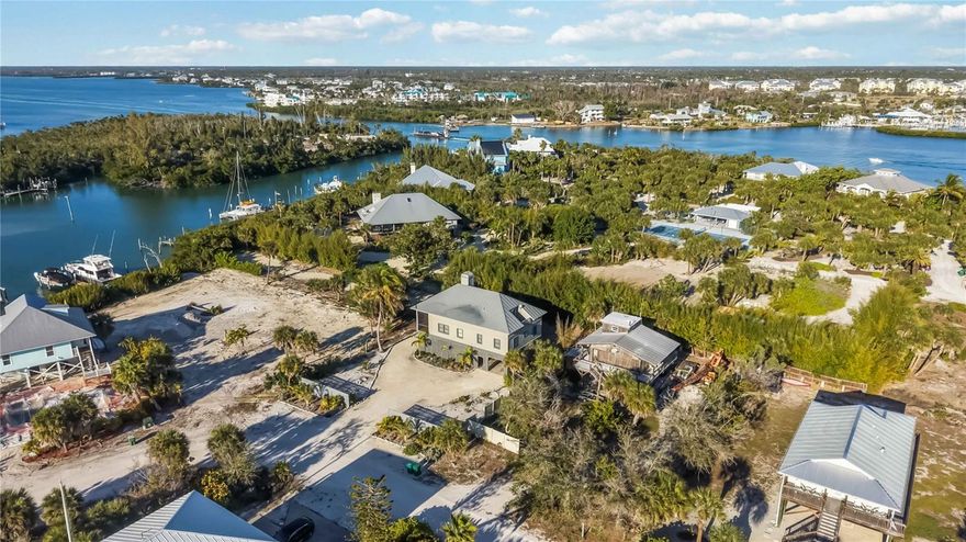 Experience the unmatched allure of Palm Island, one of Florida’s most secluded and luxurious coastal escapes. This seven-mile barrier island, nestled between Sarasota and Fort Myers on the Gulf Coast, is accessible only by car ferry—instantly creating an atmosphere of exclusivity and tranquility from the moment you arrive. Here, sugar-white beaches, serene harbors, winding lagoons, world-class fishing, and extraordinary shelling become the backdrop to a lifestyle defined by relaxation and natural beauty.
Set on the intracoastal waterway, this stunning home offers approximately 1,800 square feet of inviting living space with three beautifully appointed bedrooms and two baths. The dramatic loft-style primary suite features a queen bed, its own sitting area with a convertible single, and even a full bed set within an expansive walk-in closet. The additional bedrooms provide generous accommodations, including two full beds in one room and a queen in the other, ensuring comfort for family and guests alike.
The expansive great room elevates coastal living with its corner wood-burning coral fireplace, soaring vaulted ceilings, and a fully equipped kitchen boasting a gas cooktop—ideal for relaxed evenings or entertaining. Step onto the screened balcony for delightful peek-a-boo views of the canal and intracoastal, or retreat to the private third-floor terrace off the loft bedroom for a peaceful morning coffee high above the island.
The property’s deep-water, double-sided dock—with both electric and water—invites you to launch into endless boating adventures. Below the home, a beautifully pavered area creates a breezy open-air retreat complete with an outdoor shower, offering even more space to enjoy island living.
Palm Island’s charm extends beyond the home with the beloved Rum Bay Restaurant, its adjacent ice cream shop, and the island’s signature amenities including kayak, paddleboard, and golf cart rentals. The ferry runs daily, offering seamless access to your private sanctuary—just drive aboard, cross the water, and step into a world where life slows down and serenity takes center stage.
Palm Island is more than a destination; it is a truly extraordinary place to call home.